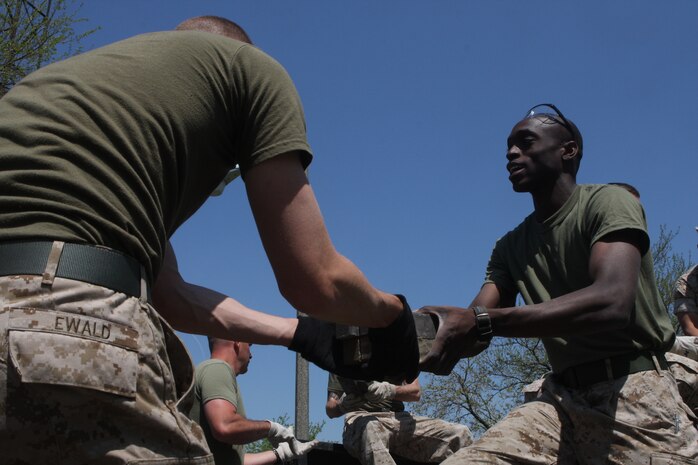 Marines with 1st Marine Division pass bricks to be placed at the base of a flagpole at Riis Park in Chicago May 12, 2009. Marines are cleaning up parks as well as taking part in other community services and efforts as part of Marine Week being held in Chicago. (U.S. Marine Corps photo by Cpl. Seth Maggard/Released)
