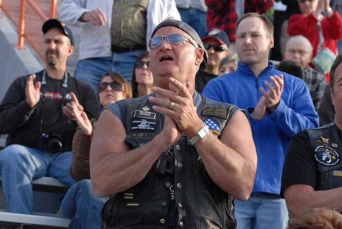 Joe Alger, president of J.A. Frate trucking company, enjoys a performace by the Marine Corps Battle Color Detachment at Oak Park Forest River High School Staduim May 12, during Marine Week 2009.