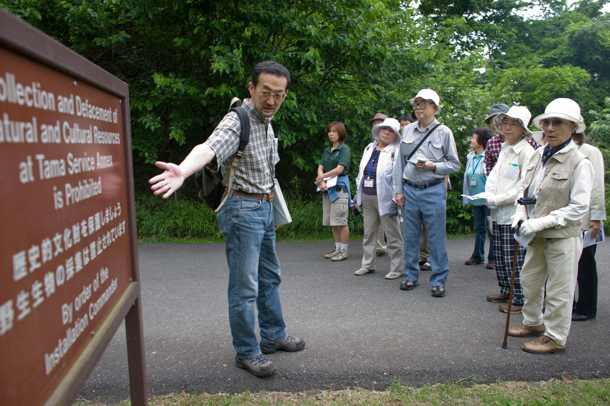 INAGI CITY, Japan -- Yoshitaka Yamaguchi, 374th Civil Engineer Squadron Environmental Flight, leads an eco tour of the Tama Hills Recreation Area May 13 for citizens of Inagi City. Yokota civil engineers lead five eco tours each year for citizens of Inagi City and Tama City, two communities which surround the recreation area. The site, a former Japanese Imperial Army munitions processing and storage plant, was so well concealed by the surrounding terrain that it remained undetected by Allied forces throughout World War II. Officials maintain the site's biodiversity and have also erected historical plaques throughout the 250-acre site containing bunkers, foundations and tunnels. (U.S. Air Force photo/Osakabe Yasuo)