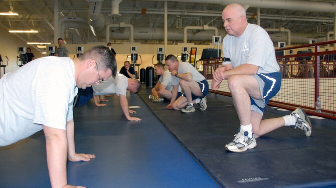 ELMENDORF AIR FORCE BASE, Alaska – Master Sgt. Dennis Moore, 477th Maintenance Squadron, counts push-ups for Senior Airman Michael Lowe, 477th Aircraft Maintenance Squadron, during their annual physical training test at the fitness center May 3. Airmen from Air Force Reserve Command’s 477th Fighter Group tested their Fit to Fight capability during their Reserve Unit Training Assembly with organized unit PT as well. (U.S. Air Force photo/Staff Sgt. Andrea Knudson)