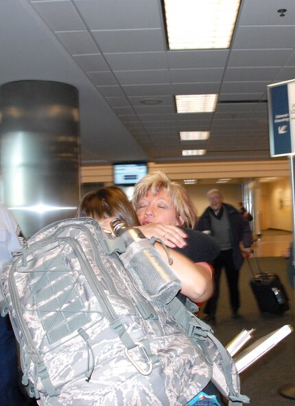 ELMENDORF AIR FORCE BASE, Alaska – Lynda Davis, Air Force Reserve Command’s 477th Fighter Group commander’s secretary, gives Maj. Lisa Reaver a tight hug seconds before Major Reaver departs for Kirkuk, Iraq, May 4. Major Reaver previously served as executive officer for the 477th FG commander, and is currently serving as the chief of protocol for the 506th Air Expeditionary Group. (U.S. Air Force photo/Staff Sgt. Andrea Knudson)