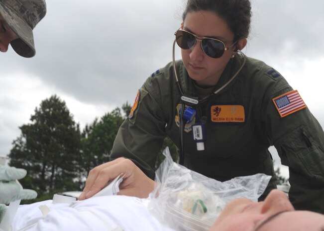 Captain Melissa Ellis-Yarian listens to the heartbeat of a victim after a simulated bomb explosion on Charleston AFB May 13. The Medical Group was part of the first responders team during the emergency management inspection conducted during the base wide Air Mobility Command unit compliance inspection. Capt. Ellis-Yarian is a doctor with the 437th Medical Group. (U.S. Air Force photo/Senior Airman Katie Gieratz)