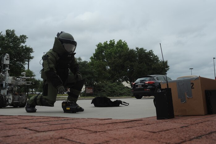 Staff Sgt. Chris Ferrell inspects a suspicious package at the maintenance group building here May 13. Explosive ordnance disposal Airmen safely examine and dispose of explosive devices. Charleston AFB conducted an emergency management inspection during a base-wide Air Mobility Command unit compliance inspection to ensure misison readiness. Sergeant Ferrell is an explosive ordnance technician assigned to the 437th Civil Engineer Squadron. (U.S. Air Force photo/Senior Airman Katie Gieratz)