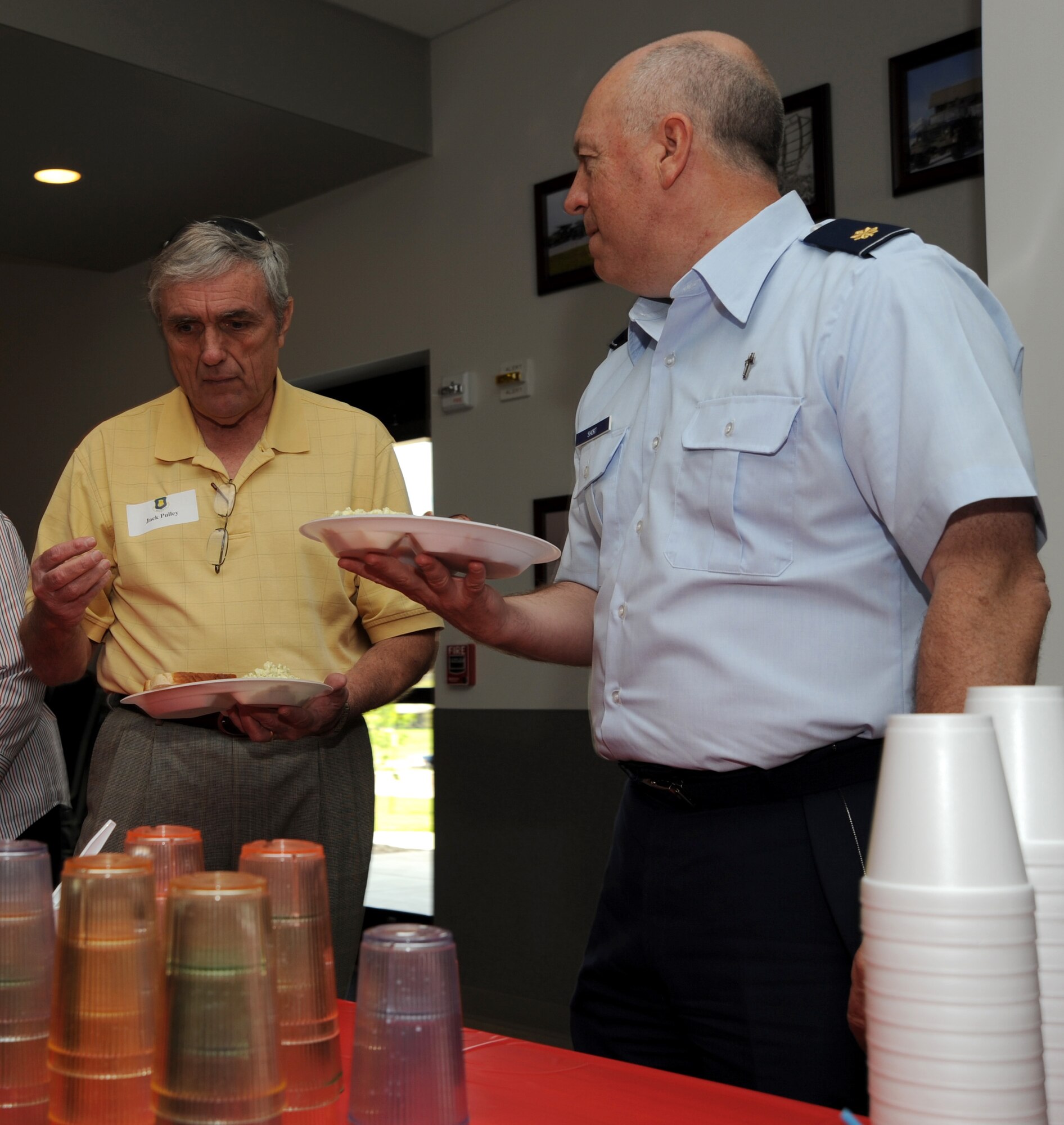 MCCONNELL AIR FORCE BASE, Kan. -- Jack Pulley, McConnell Golden Eagle, speaks with Chaplain (Maj.) Boyd Short, 22nd Air Refueling Wing, during a civic leaders luncheon at the 184th Jayhawk Roost dining facility, May 11. Civic leader luncheons are held once a month to foster communication between McConnell and the surrounding community. (Photo by Senior Airman Roy Lynch) 