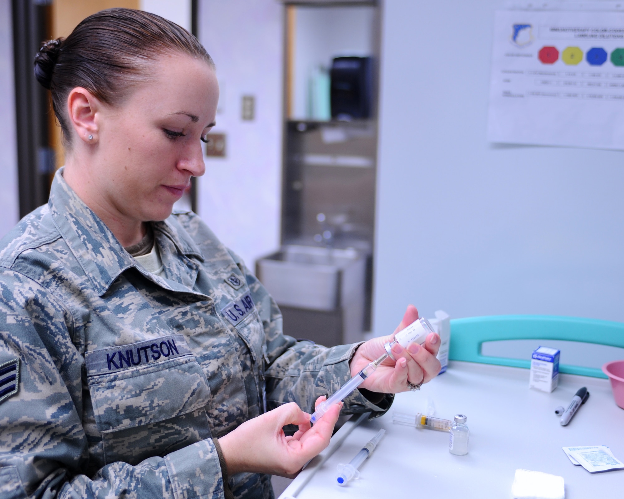 Senior Airman Megan Knutson, 28th Medical Operations Squadron medical technician, prepares an immunization as part of deployment training for Airmen here, May 13. The immunizations clinic processes approximately more than 20 deploying Airmen weekly. (U.S. Air Force photo/Senior Airman Kasey Zickmund)