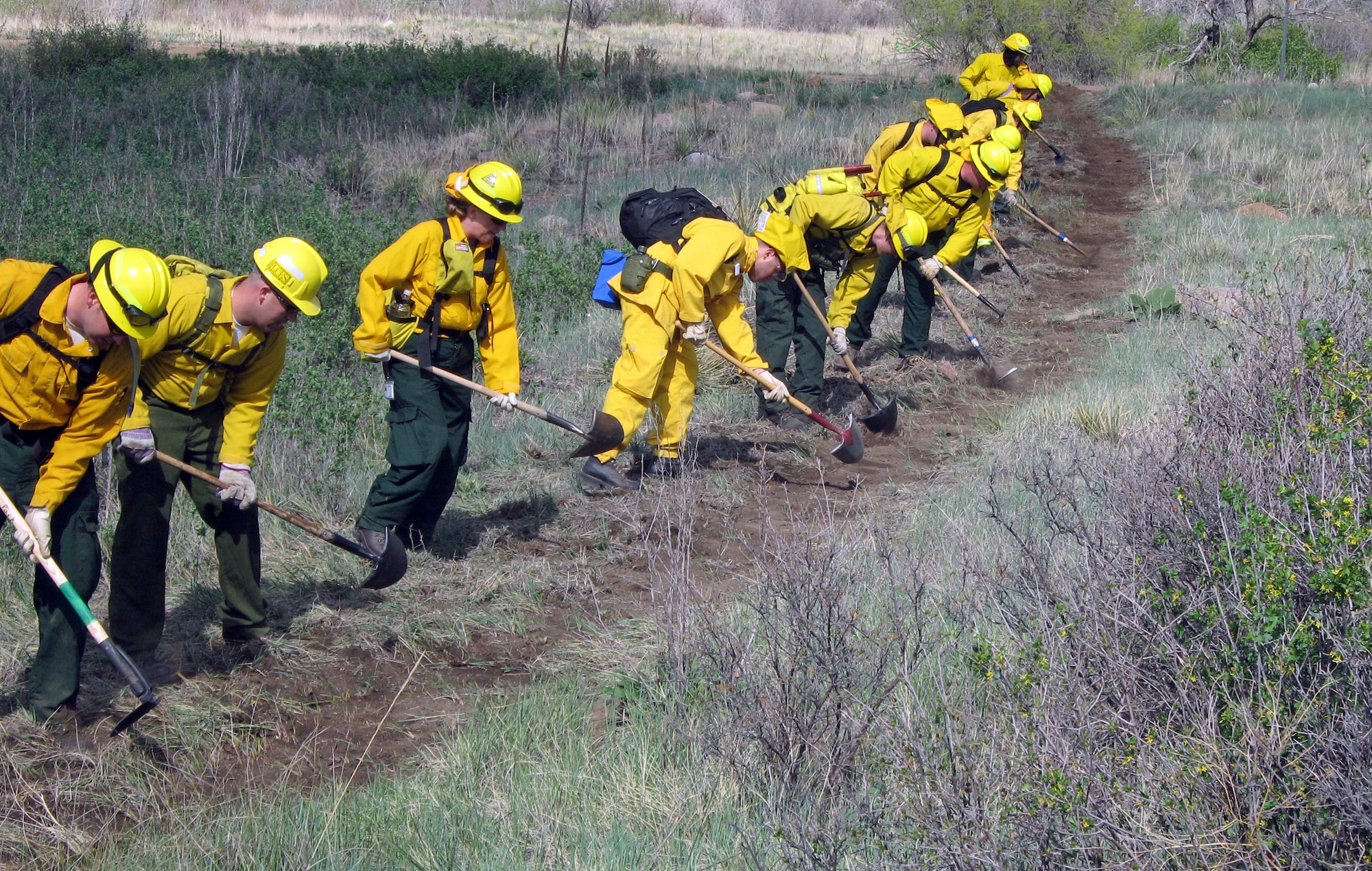 Firefighters participating in the Wildfire Academy, hosted by the 721st Civil Engineer fire department, dig a fire line or “stop line” at Fort Carson during a training exercise. Stop lines are fire control measures designed to cut off a wildfire before it spreads. Approximately 100 enlisted and civilian fire fighters from Peterson, Cheyenne Mountain and other local federal, state and local agencies took part in the week-long training academy which culminated with a 100 acre live fire exercise conducted at Fort Carson and was designed to promote first responder teamwork.  (Air Force photo by Chris Miller) 