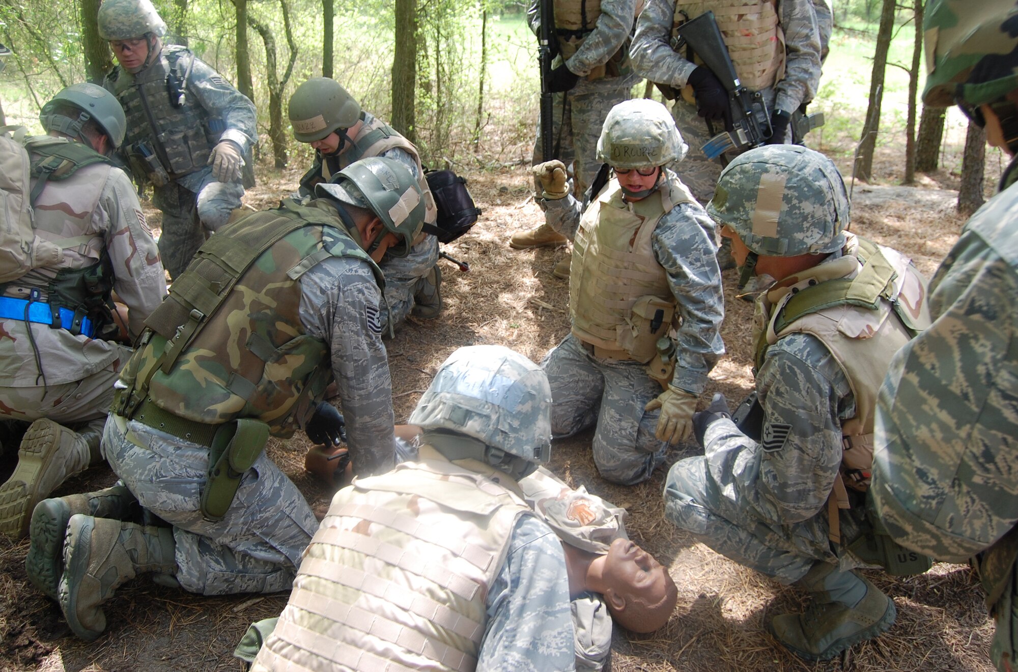Students in the Advanced Contingency Skills Training Course practice combat first aid techniques during training on a Fort Dix, N.J., range on May 11, 2009.  The training, taught by the U.S. Air Force Expeditionary Center's 421st Combat Training Squadron on Fort Dix, prepares Airmen for upcoming deployments.  (U.S. Air Force Photo/Tech. Sgt. Scott T. Sturkol)