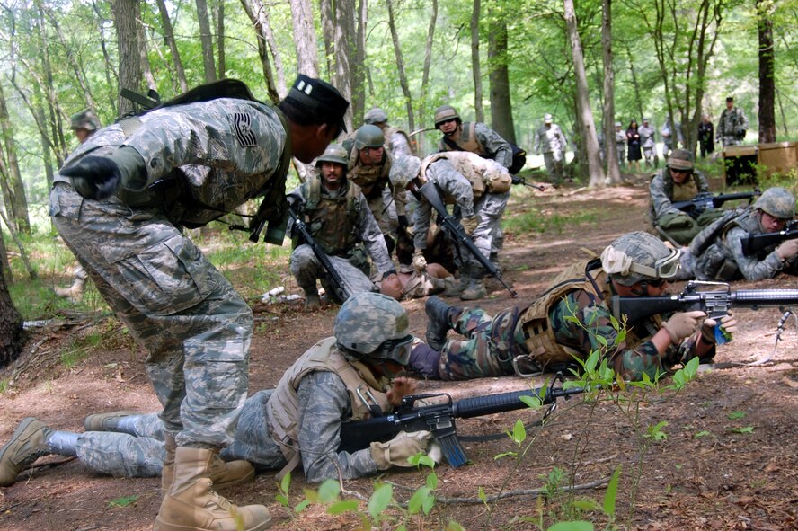 Tech. Sgt. Bernard Wilson, contingency skills instructor, provides instruction to students in the Advanced Contingency Skills Training Course as they respond to a scenario requiring response to "enemy fire" during training on a Joint Base McGuire-Dix-Lakehurst, N.J., range on May 11, 2009. The training, taught by the U.S. Air Force Expeditionary Center's 421st Combat Training Squadron on Fort Dix, prepares Airmen for upcoming deployments. One Air Mobility Command Airman from Little Rock Air Force Base, Ark., credited the training for saving her life after an improvised explosive device attack in Iraq in August 2009. (U.S. Air Force Photo/Tech. Sgt. Scott T. Sturkol) 