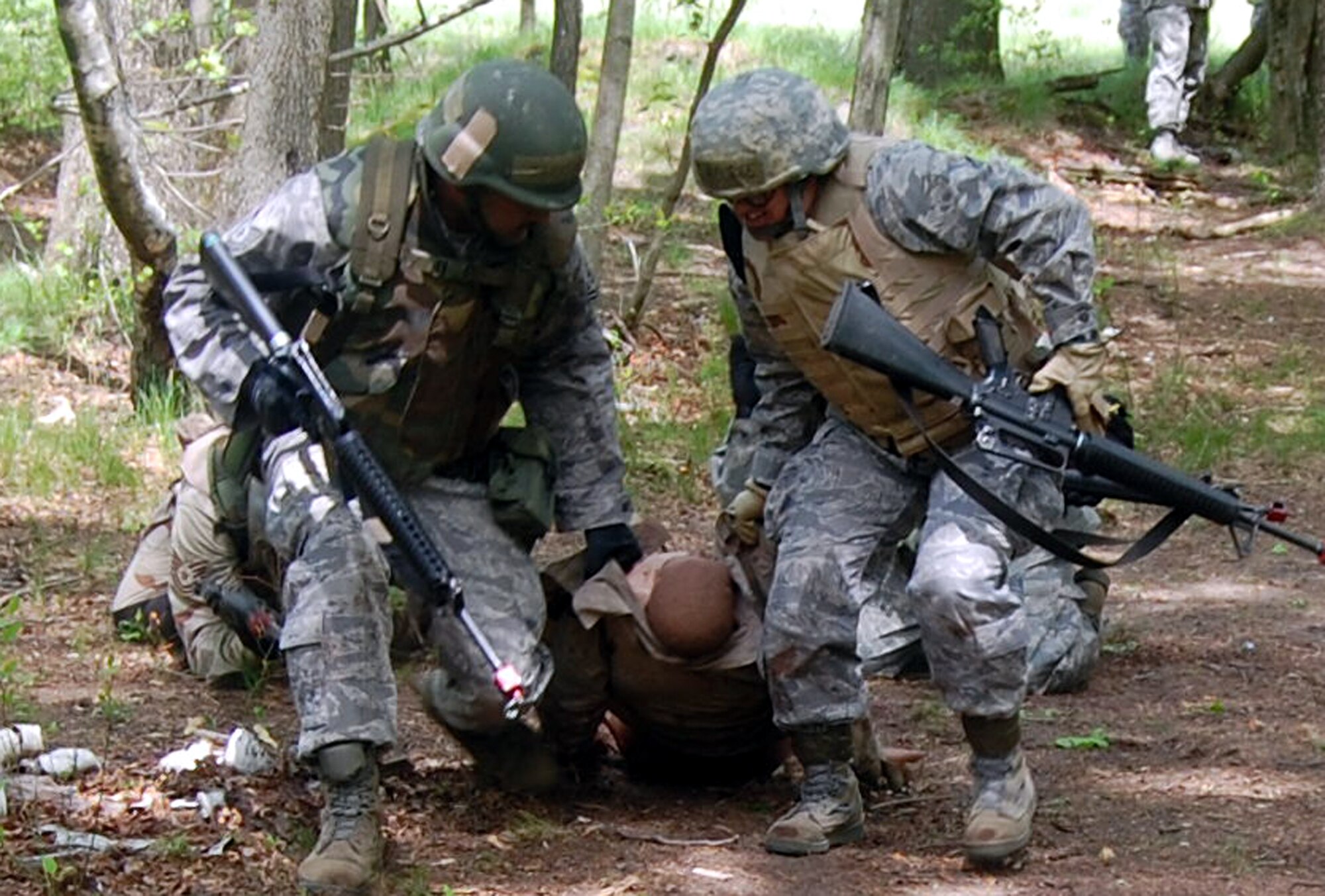 Students in the Advanced Contingency Skills Training Course move a simulated victim during training on a Fort Dix, N.J., range on May 11, 2009.  The training, taught by the U.S. Air Force Expeditionary Center's 421st Combat Training Squadron on Fort Dix, prepares Airmen for upcoming deployments.  (U.S. Air Force Photo/Tech. Sgt. Scott T. Sturkol)