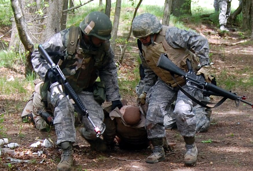Students in the Advanced Contingency Skills Training Course move a simulated victim during training on a Joint Base McGuire-Dix-Lakehurst, N.J., range on May 11, 2009. The training, taught by the U.S. Air Force Expeditionary Center's 421st Combat Training Squadron on Fort Dix, prepares Airmen for upcoming deployments. One Air Mobility Command Airman from Little Rock Air Force Base, Ark., credited the training for saving her life after an improvised explosive device attack in Iraq in August 2009. (U.S. Air Force Photo/Tech. Sgt. Scott T. Sturkol) 