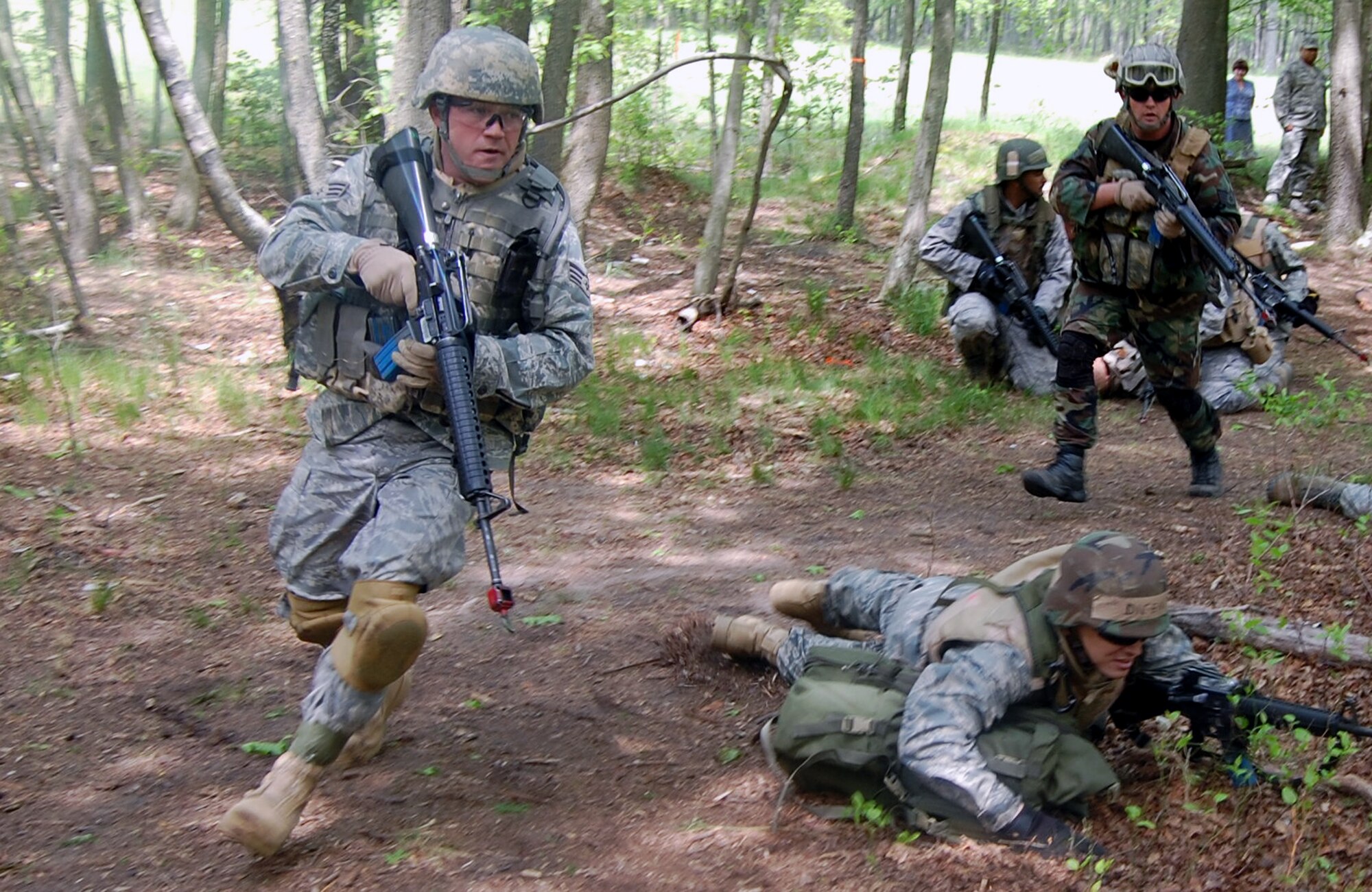 Students in the Advanced Contingency Skills Training Course respond to "enemy fire" during training on a Fort Dix, N.J., range on May 11, 2009.  The training, taught by the U.S. Air Force Expeditionary Center's 421st Combat Training Squadron on Fort Dix, prepares Airmen for upcoming deployments.  (U.S. Air Force Photo/Tech. Sgt. Scott T. Sturkol)