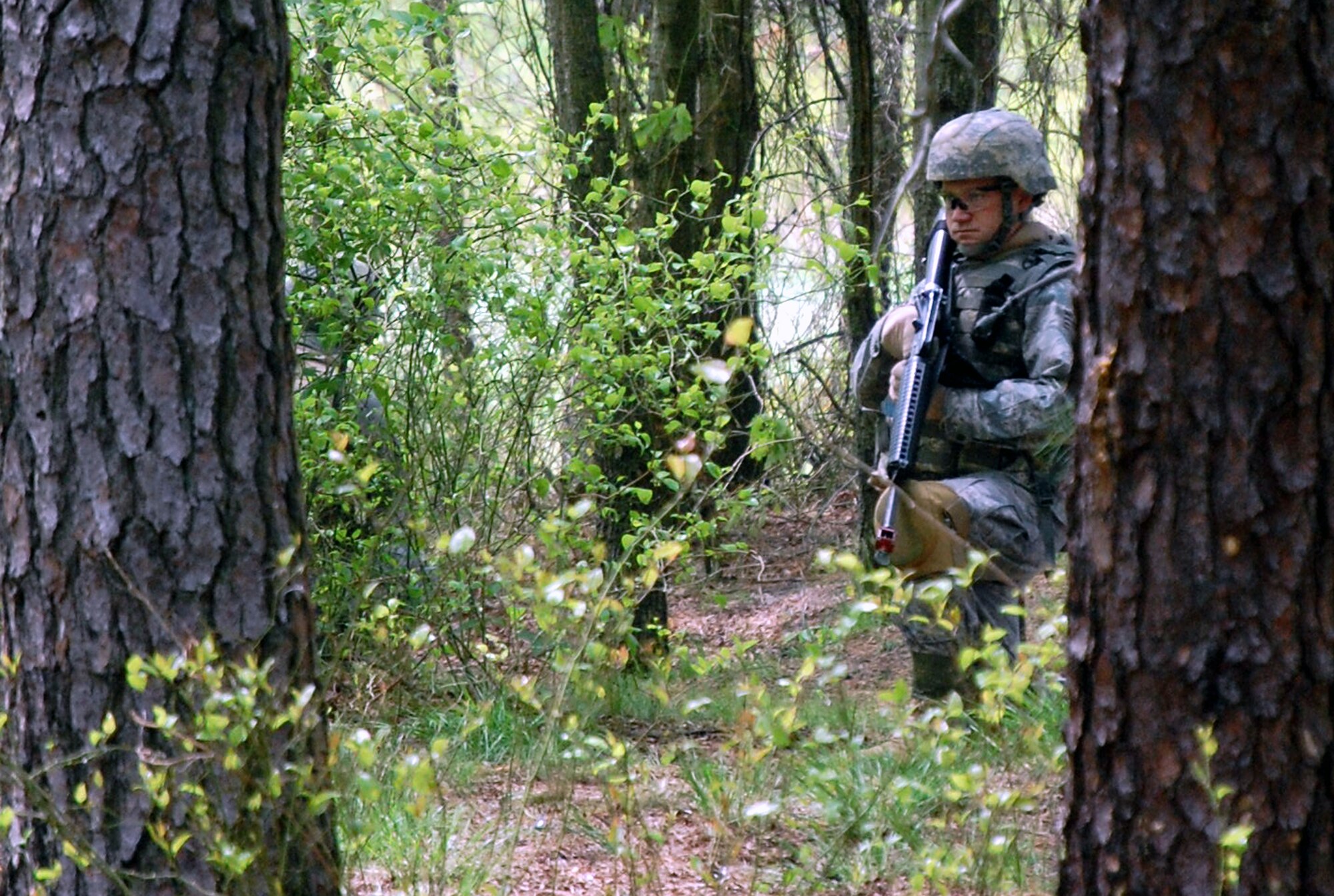 A student in the Advanced Contingency Skills Training Course finds cover during training on a Fort Dix, N.J., range on May 11, 2009.  The training, taught by the U.S. Air Force Expeditionary Center's 421st Combat Training Squadron on Fort Dix, prepares Airmen for upcoming deployments.  (U.S. Air Force Photo/Tech. Sgt. Scott T. Sturkol)
