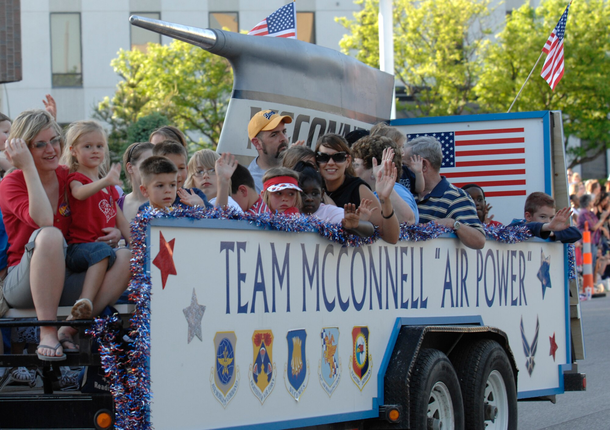 WICHITA, Kan. -- Team McConnell’s spouses of deployed members and children ride in the McConnell float during the Sundown Parade in downtown Wichita, May 8.   (Photo by Staff Sgt. Ronald Lafosse)