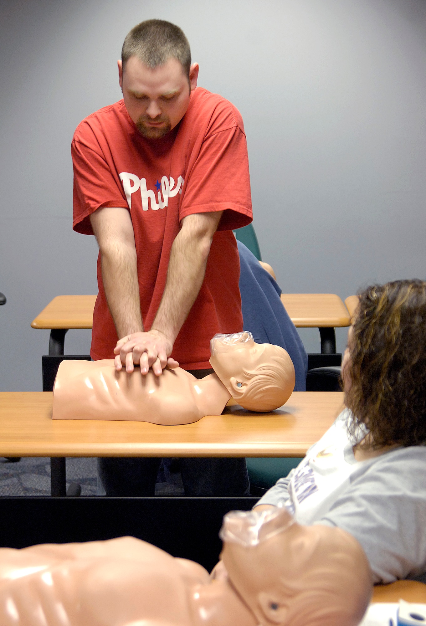 During an on-base CPR class in the 76th Maintenance Wing, Donny Ticer shows how he would respond to an emergency during an instructor-directed scenario. Mr. Ticer is a sheet metal mechanic with the 551st Commodities Maintenance Squadron. (Air Force photo by Margo Wright) 