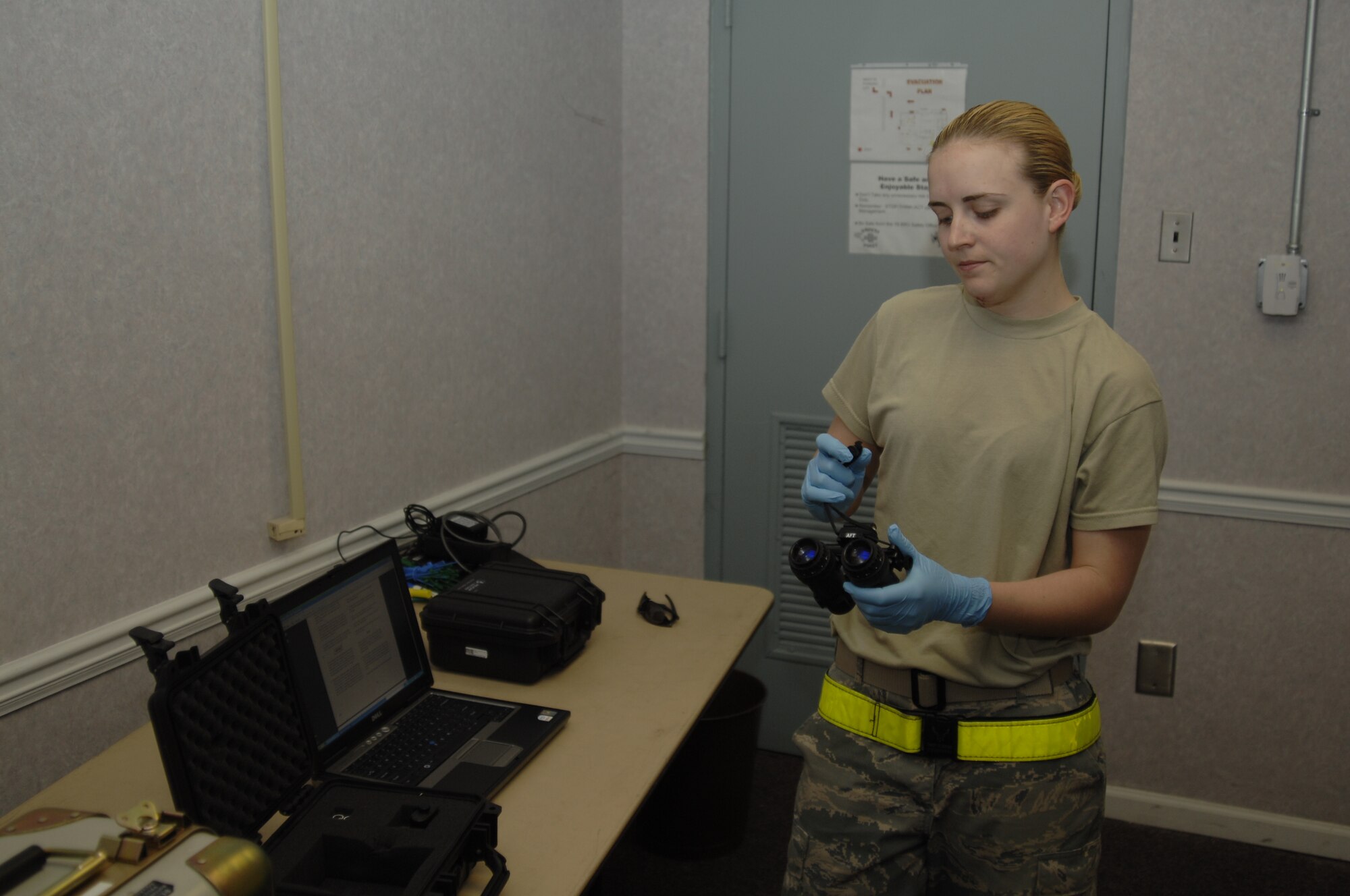 MCCONNELL AIR FORCE BASE, Kan. -- Senior Airman Tracey Holderfield, 22nd Operations Group aircrew flight equipment, performs an inspection on a pair of night vision goggles before issuing them to aircrews. Night vision goggles allow aircrews to see in near complete darkness. (Photo by Staff Sgt. Ronald Lafosse)