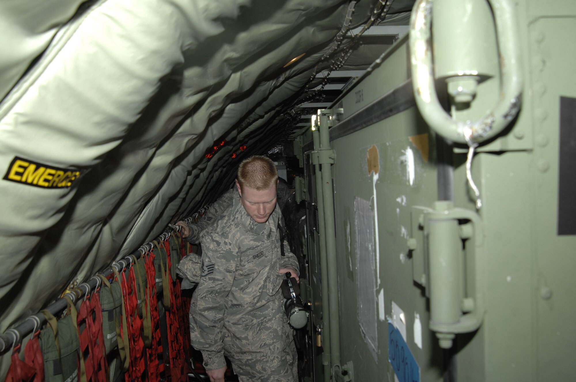 MCCONNELL AIR FORCE BASE, Kan. -- Team McConnell Airmen board a KC-135 Stratotanker loaded with four pallets totaling the length of the aircraft.  With cargo loaded, passenger seating is limited and reduces the number of Airmen that can be transported. (Photo by Staff Sgt. Ronald Lafosse)