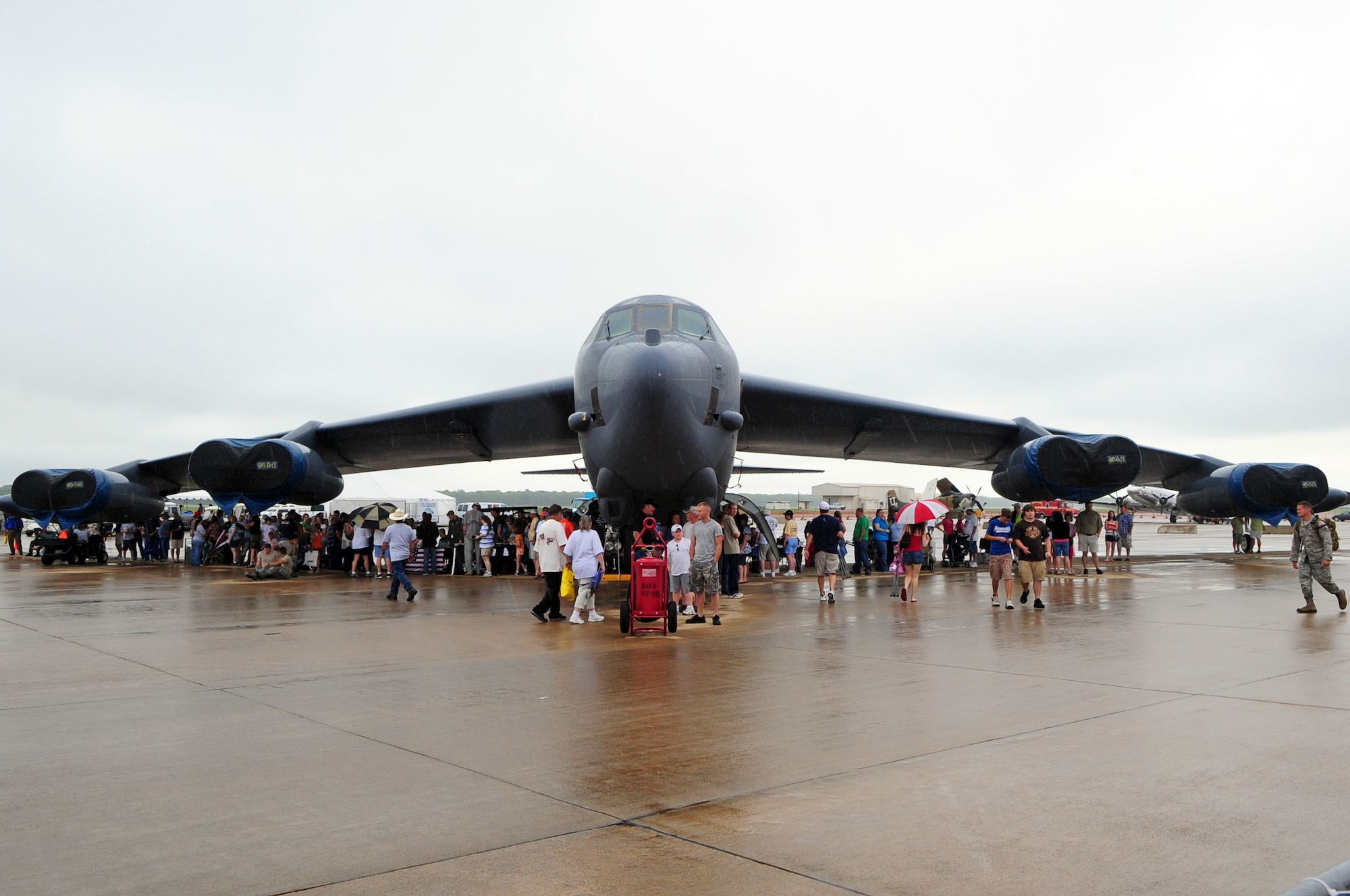 BARKSDALE AIR FORCE BASE, La. - Guests of the Defenders of Liberty Air Show take shelter under a B-52H Stratofortress as rain temporarily interrupted the show, May 10.  (U.S. Air Force photo by Senior Airman Joanna M. Kresge)(Released)