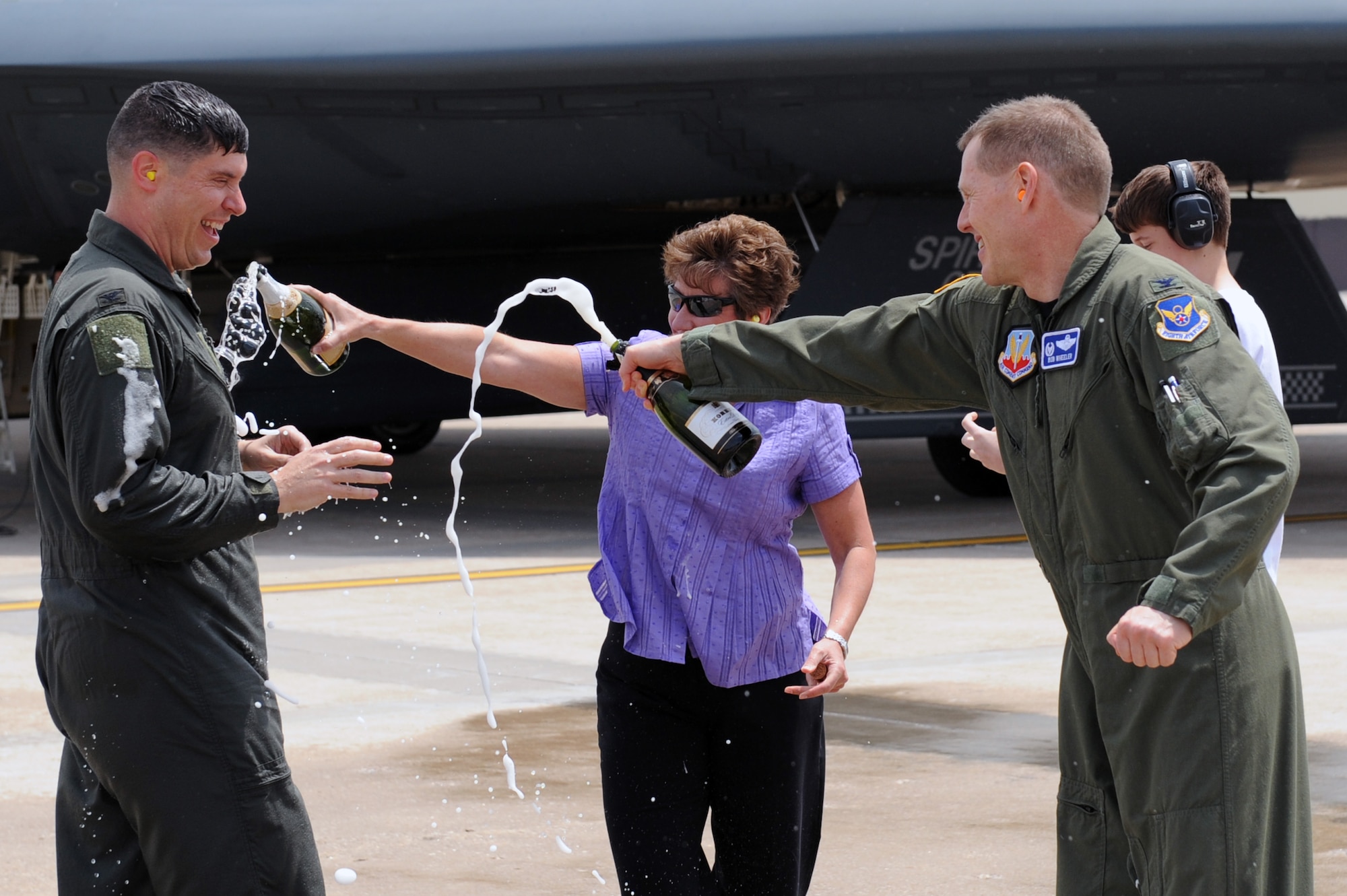 WHITEMAN AIR FORCE BASE, Mo. - Col. John Robinson, 509th Bomb Wing vice commander, gets champagne tossed on him by his wife, Jeanne, and Col. Robert Wheeler, 509th BW commander, after his final B-2 flight May 12.  (U.S. Air Force photo/ Senior Airman Jason Huddleston)