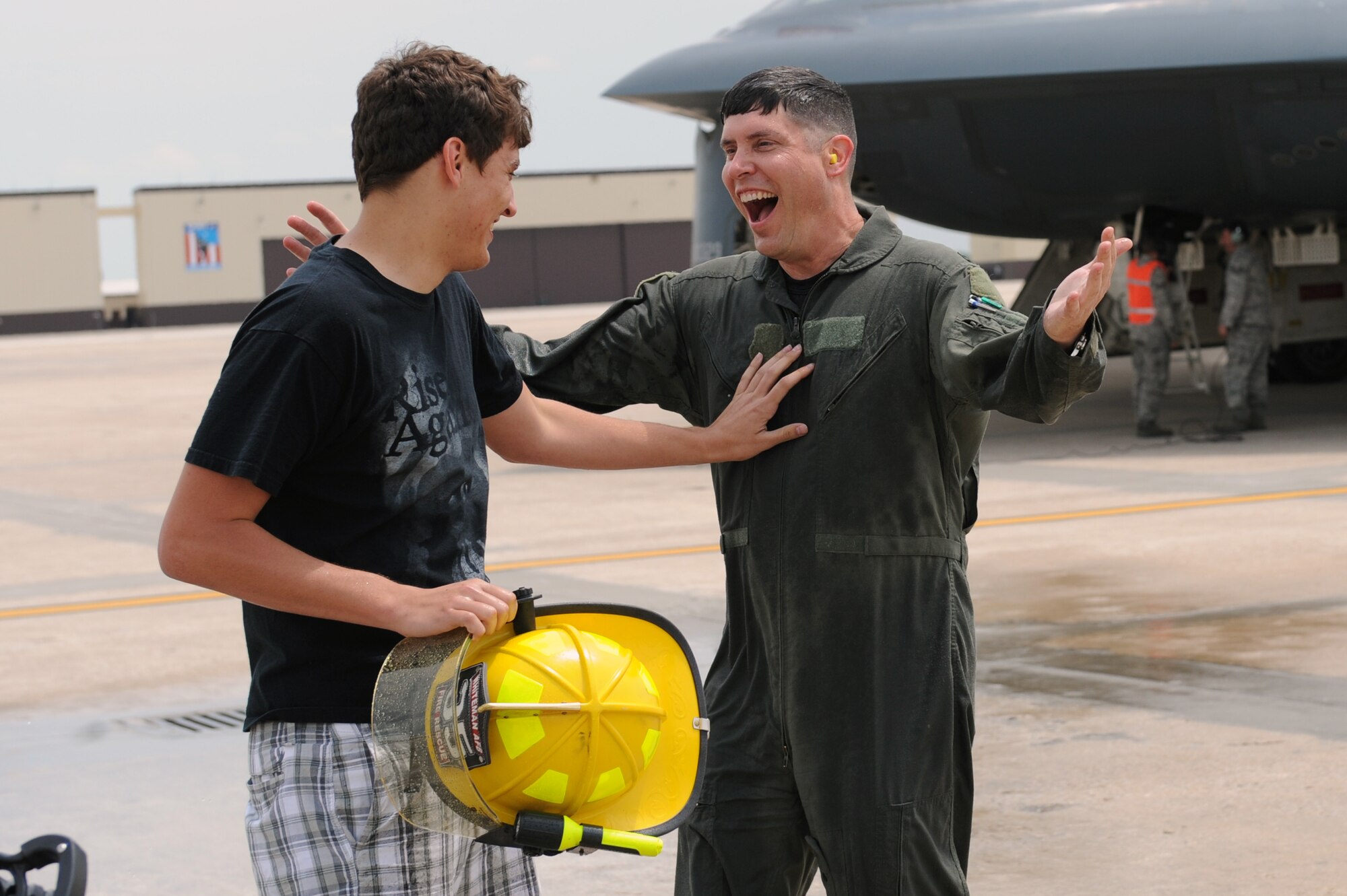 WHITEMAN AIR FORCE BASE, Mo. - Col. John Robinson, 509th Bomb Wing vice commander, gives his son, Johnny, a hug after his final B-2 flight May 12. Traditionally, when an Air Force member receives their final flight on an aircraft, their family or peers sprays them with a fire hose to commemorate the event.  (U.S. Air Force photo/Senior Airman Jason Huddleston)