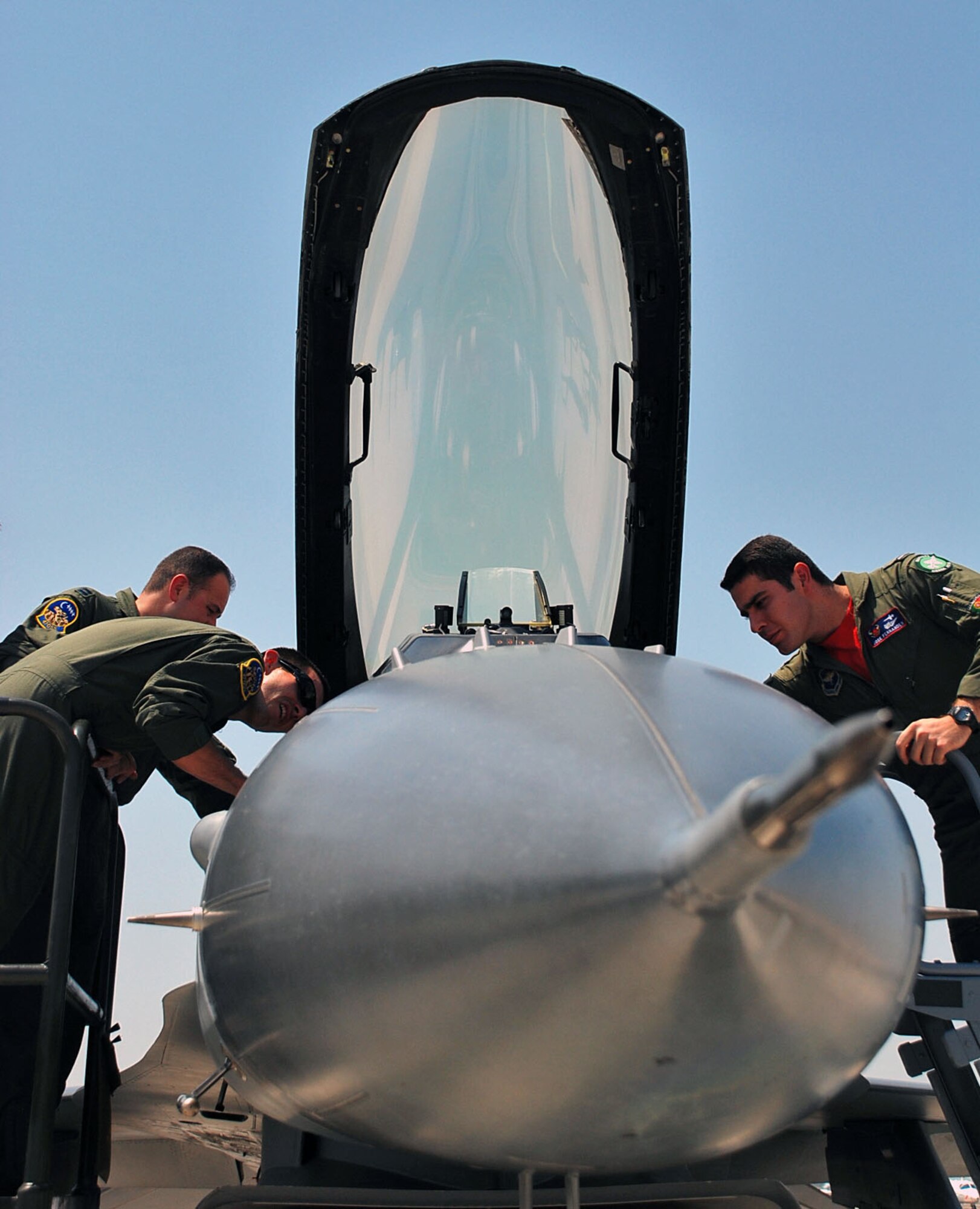 LAUGHLIN AIR FORCE BASE, Texas – First Assignment Instructor Pilots from the 47th Operations Group, look over an F-16 Fighting Falcon during FAIPAPALOOZA here May 8. For the first time in history, Laughlin hosted the Air Education and Training Command event with FAIPs from across the command. It was a weekend–long event that included static displays of an F-16 and PC-12 and instruction from the pilots to help get them acquainted with major weapons systems they might fly in the future.  Also as a part of FAIPAPALOOZA Maj. Gen. Anthony Przybyslawski, Air Education and Training Command vice commander, spoke to a large group of the FAIP’s here to share wisdom and experience.  (U.S. Air Force photo by Airman 1st Class Sara Csurilla) 