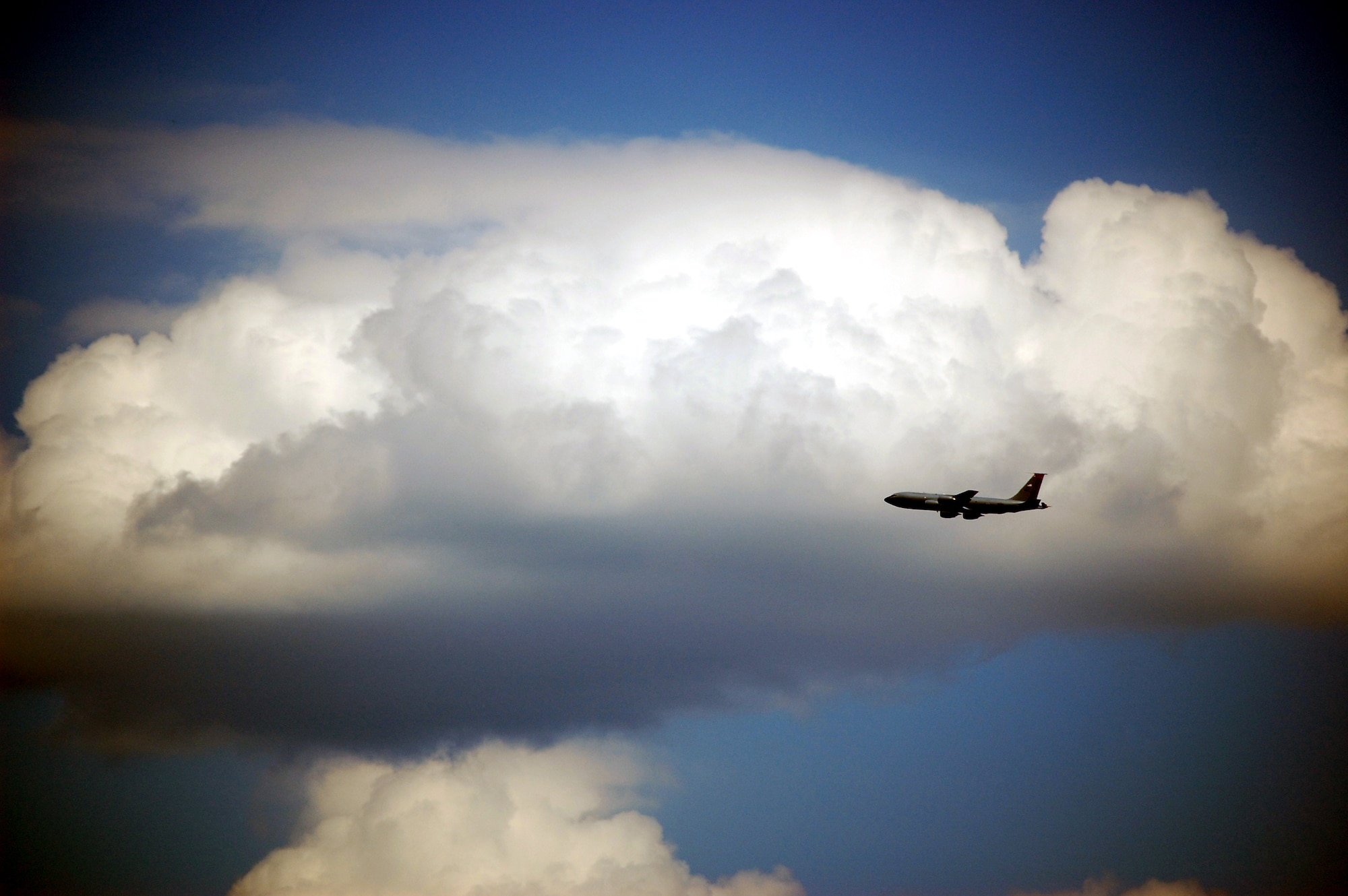 A KC-135 Stratotanker flies over McGuire Air Force Base, N.J., on its way to an air refueling mission on May 12, 2009.  The KC-135, which is assigned to 108th Air Refueling Wing at McGuire, is one of aircraft that helps the Air Force and Air Mobility Command  to "fly, fight and win...in air, space and cyberspace."  (U.S. Air Force Photo/Tech. Sgt. Scott T. Sturkol)