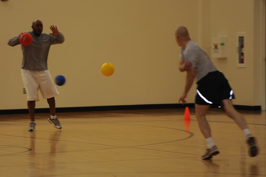 Tech. Sgt. Kendrick Ross, from the U.S. Air Force Expeditionary Center's Resources Directorate, jumps to miss being hit by dodgeballs May 8 during the center's dodgeball tournament held at the McGuire Air Force Base, N.J., fitness center. The tournament was part of a fundraising effort for the Expeditionary Center's 15th anniversary committee.   (U.S. Air Force Photo/Staff Sgt. Nathan G. Bevier) 