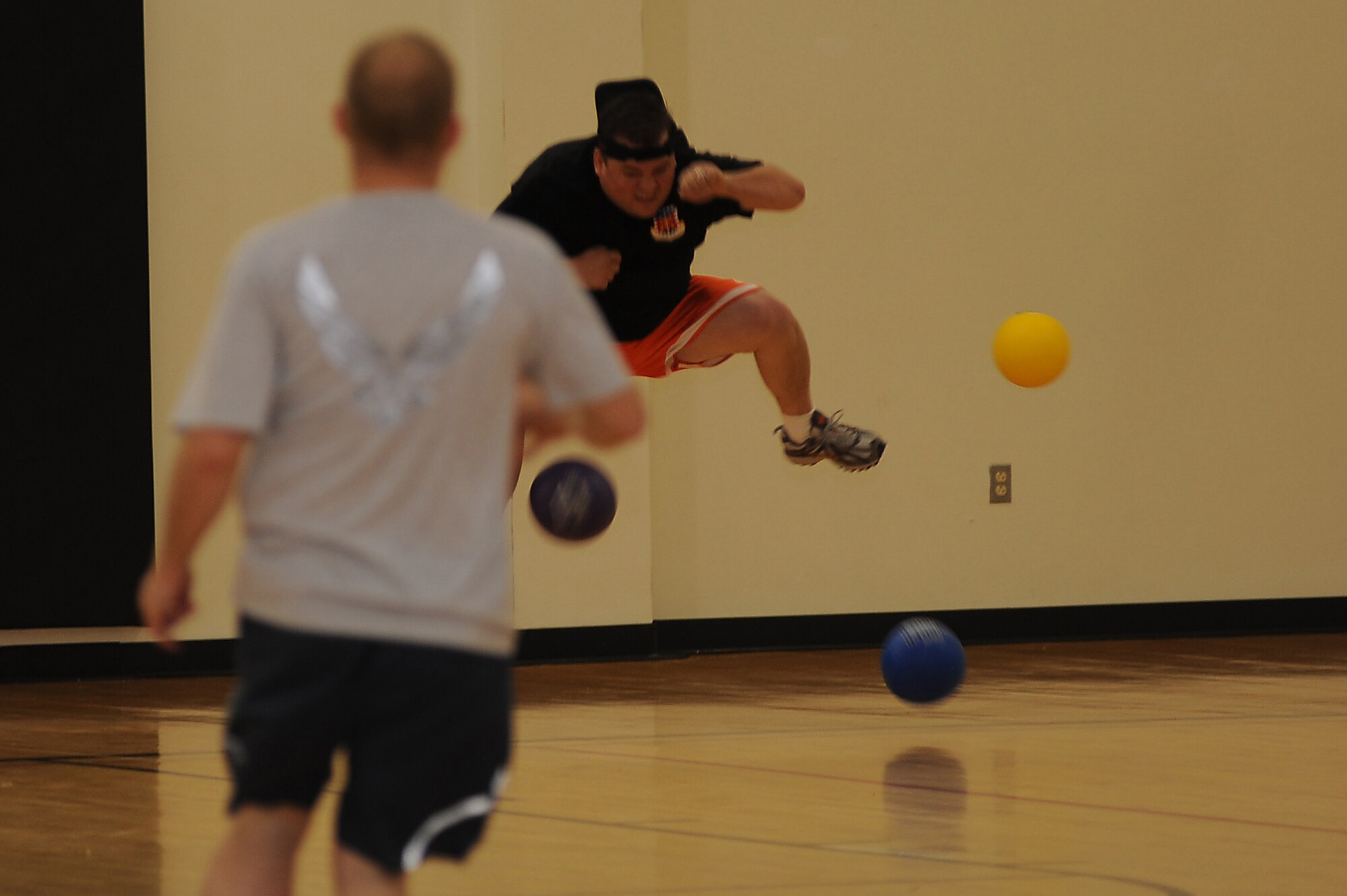 Tech. Sgt. James Carson, from the U.S. Air Force Expeditionary Center's Mobility Operations School, jumps to miss being hit by dodgeballs May 8 during the center's dodgeball tournament held at the McGuire Air Force Base, N.J., fitness center. The tournament was part of a fundraising effort for the Expeditionary Center's 15th anniversary committee.   (U.S. Air Force Photo/Staff Sgt. Nathan G. Bevier) 