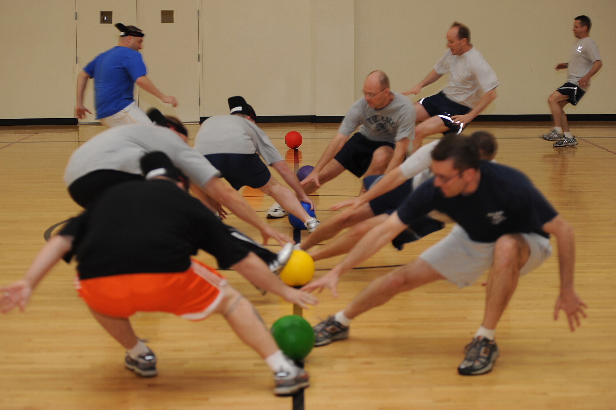 Airmen from the U.S. Air Force Expeditionary Center rush to retrieve dodgeballs from the starting line May 8 during the center's dodgeball tournament held at the McGuire Air Force Base, N.J., fitness center. The tournament was part of a fundraising effort for the Expeditionary Center's 15th anniversary committee.   (U.S. Air Force Photo/Staff Sgt. Nathan G. Bevier) 