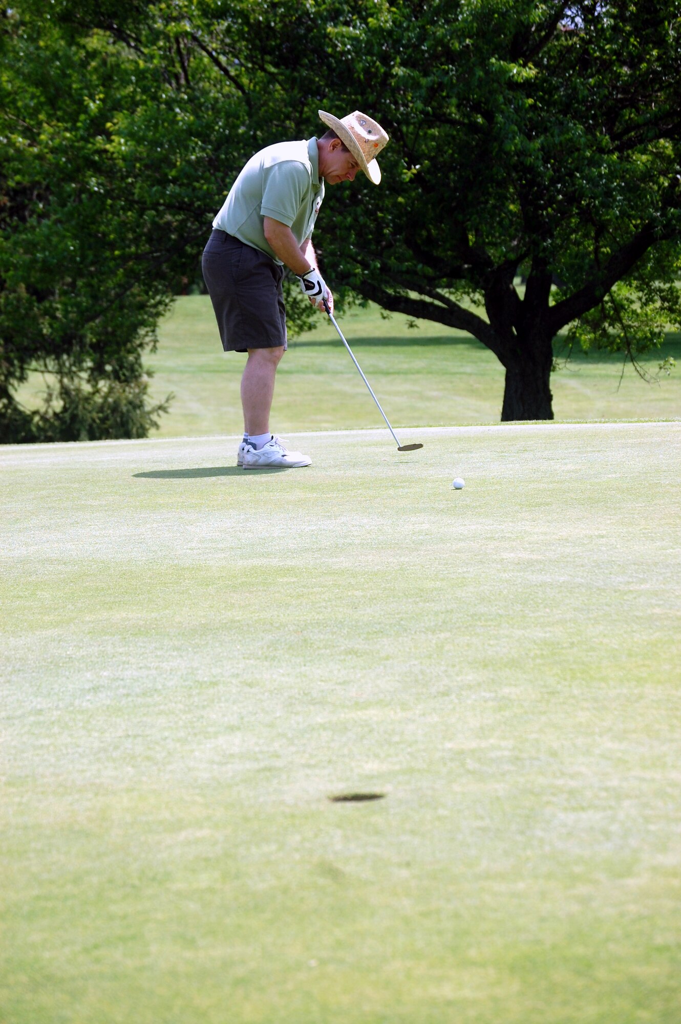 Lt. Col. Mitchell Monroe, commander for the U.S. Air Force Expeditionary Center's 421st Combat Training Squadron, putts for par during the 2009 Nick Grand Memorial Golf Tournament on the Fort Dix, N.J., golf course on May 12.  The tournament is annual fundraising tournament for the Expeditionary Center's Top Three organization.  (U.S. Air Force Photo/Tech. Sgt. Scott T. Sturkol)