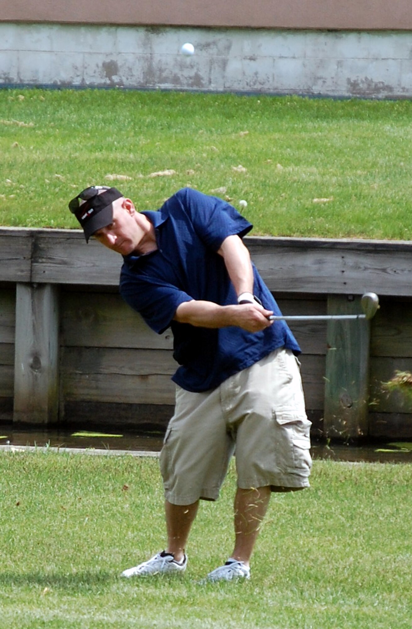 Staff Sgt. Justin Parnell, from the 819th Global Support Squadron of McGuire Air Force Base, N.J., chips a shot on the 16th hole during the 2009 Nick Grand Memorial Golf Tournament on the Fort Dix, N.J., golf course on May 12, 2009.  The tournament is annual fundraising tournament for the U.S. Air Force Expeditionary Center's Top Three organization.  (U.S. Air Force Photo/Tech. Sgt. Scott T. Sturkol)