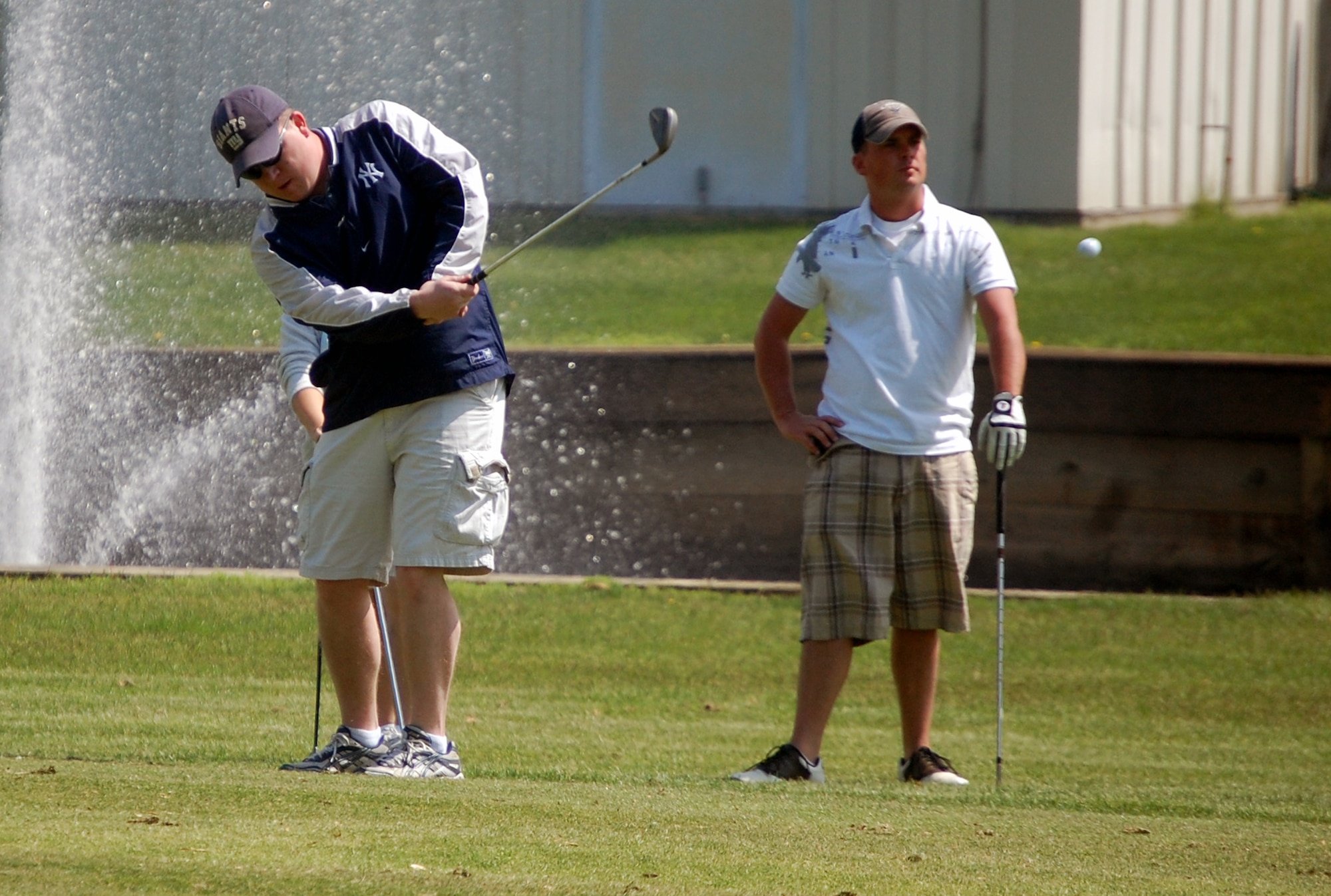 Tech. Sgt. Joe Neubauer, from the U.S. Air Force Expeditionary Center's Mobility Operations School, chips a shot during the 2009 Nick Grand Memorial Golf Tournament on the Fort Dix, N.J., golf course on May 12, 2009.  The tournament is annual fundraising tournament for the Expeditionary Center's Top Three organization.  (U.S. Air Force Photo/Tech. Sgt. Scott T. Sturkol)