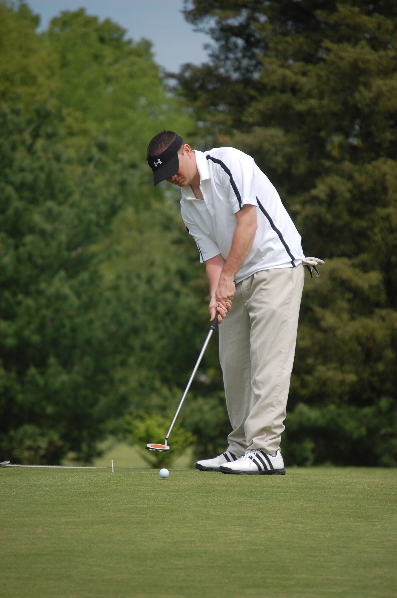 Staff Sgt. Tim Land, from the U.S. Air Force Expeditionary Center's Mobility Operations School, putts the ball on the 16th hole during the 2009 Nick Grand Memorial Golf Tournament on the Fort Dix, N.J., golf course on May 12, 2009.  The tournament is an annual fundraising tournament for the Expeditionary Center's Top Three organization.  (U.S. Air Force Photo/Tech. Sgt. Scott T. Sturkol)