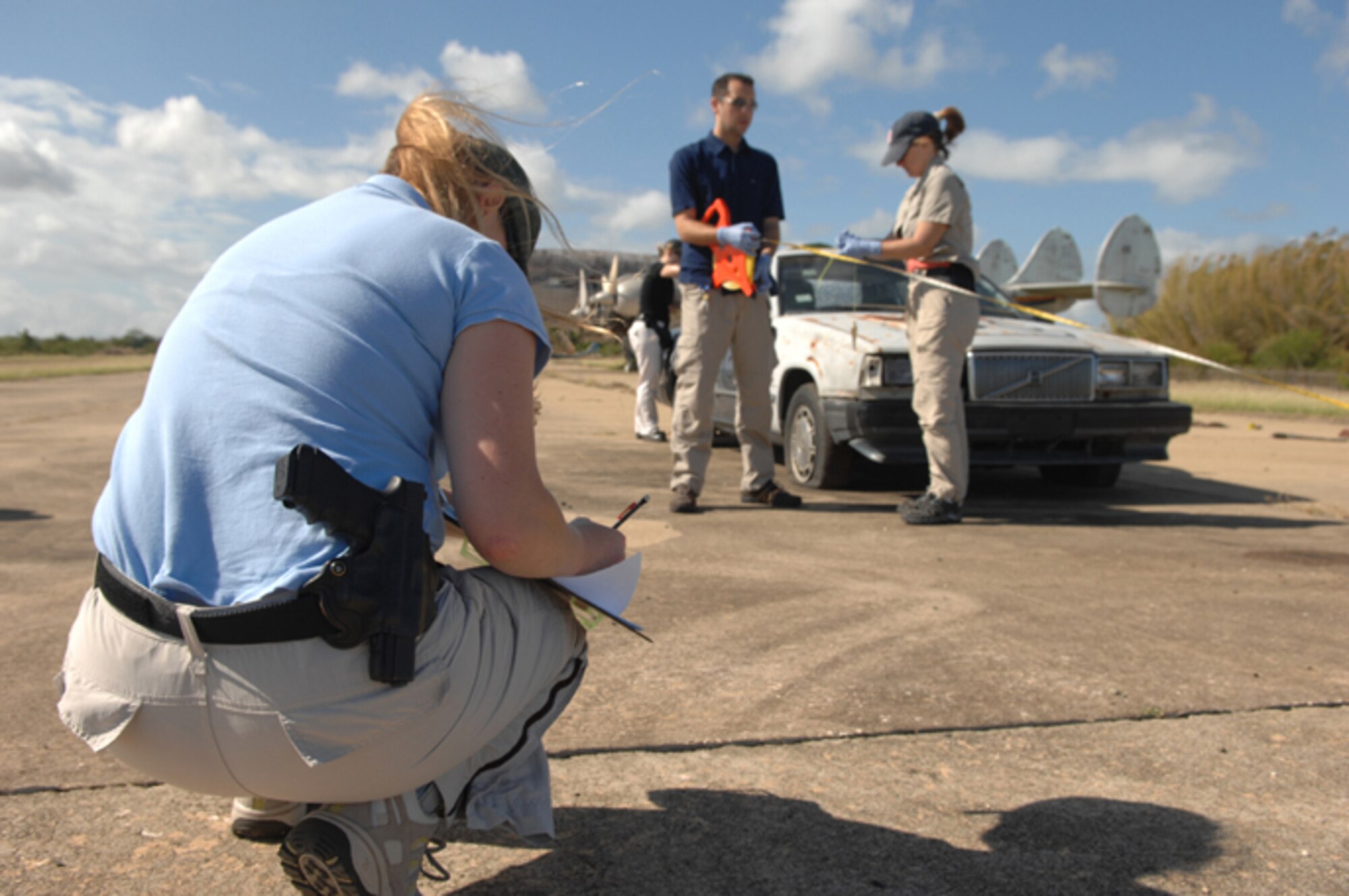 An FBI agent on a rapid deployment team sketches a car while processing a crime scene during Patriot Hoover 2009 at Ramey airfield in Aguadilla, Puerto Rico, on May 2, 2009. In addition to units from Air Force Reserve Command and the Puerto Rico Air National Guard, the large-scale air mobility exercise involved Federal Bureau of Investigation rapid deployment teams from Washington, D.C.; Miami; New York City and Los Angeles. (U.S. Air Force photo/Staff Sgt. Daniel St. Pierre)