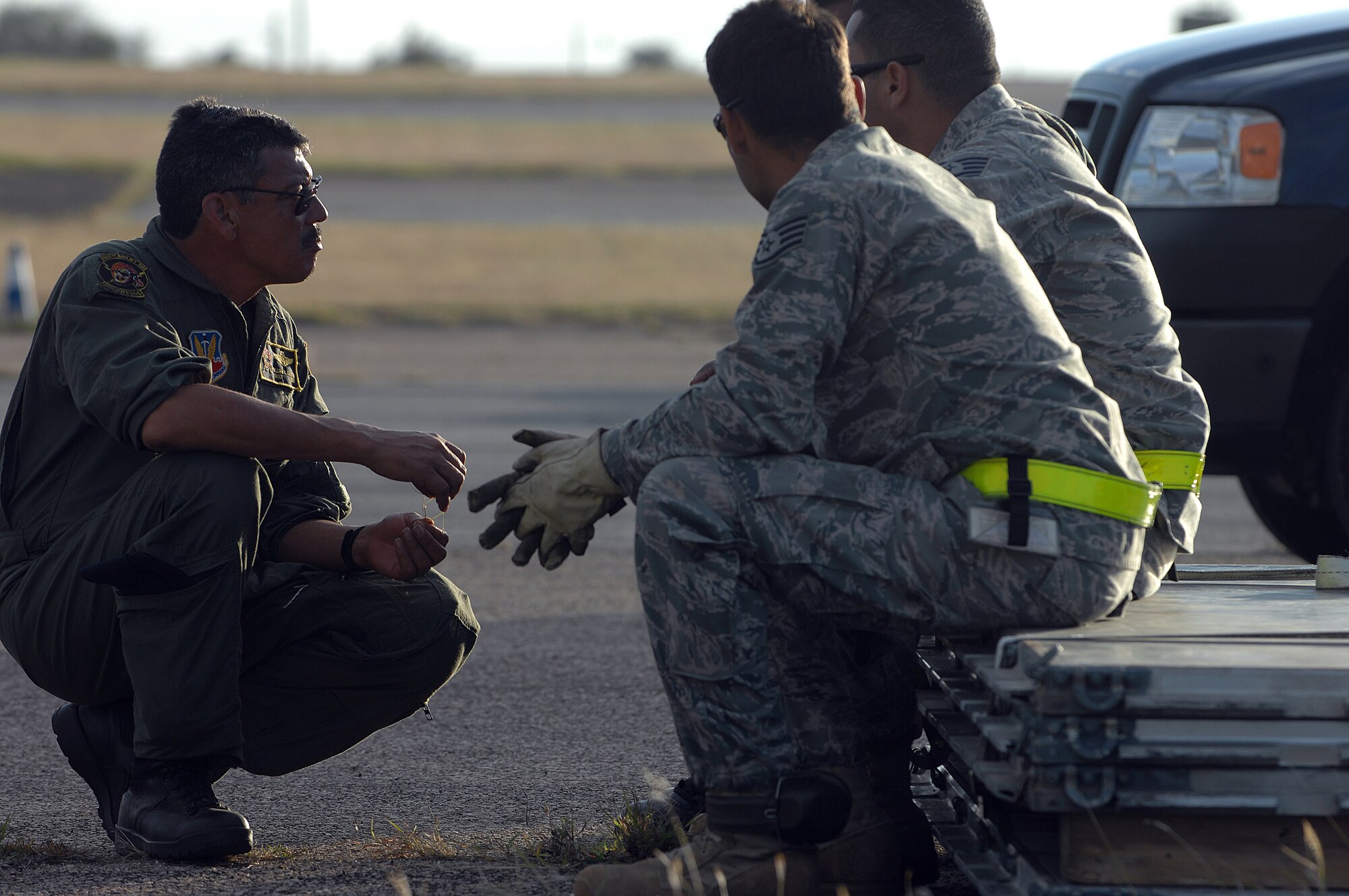 Senior Master Sgt. William Castro, left, a loadmaster from the 198th Airlift Squadron, talks to fellow Puerto Rico Air National Guardsmen on May 2, 2009, while planning for night operations at Ramey airfield, Puerto Rico. They participated in Patriot Hoover 2009, a large-scale air mobility exercise involving Air Force Reserve Command airlift control flights, aerial ports and flying units and the FBI. (U.S. Air Force photo/Master Sgt Rick Sforza)