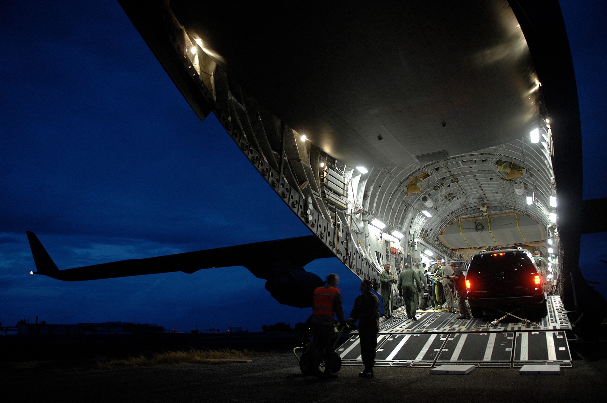 An aircrew from Air Force Reserve Command’s 729th Airlift Squadron, March Air Reserve Base, Calif., prepares to off-load an FBI rapid deployment team and vehicles from a C-17A Globemaster III aircraft on April 29, 2009, at Ramey airfield, Puerto Rico. FBI agents took part in Patriot Hoover 2009, a large-scale air mobility exercise involving AFRC and the Puerto Rico Air National Guard units. (U.S. Air Force photo/Master Sgt Rick Sforza)