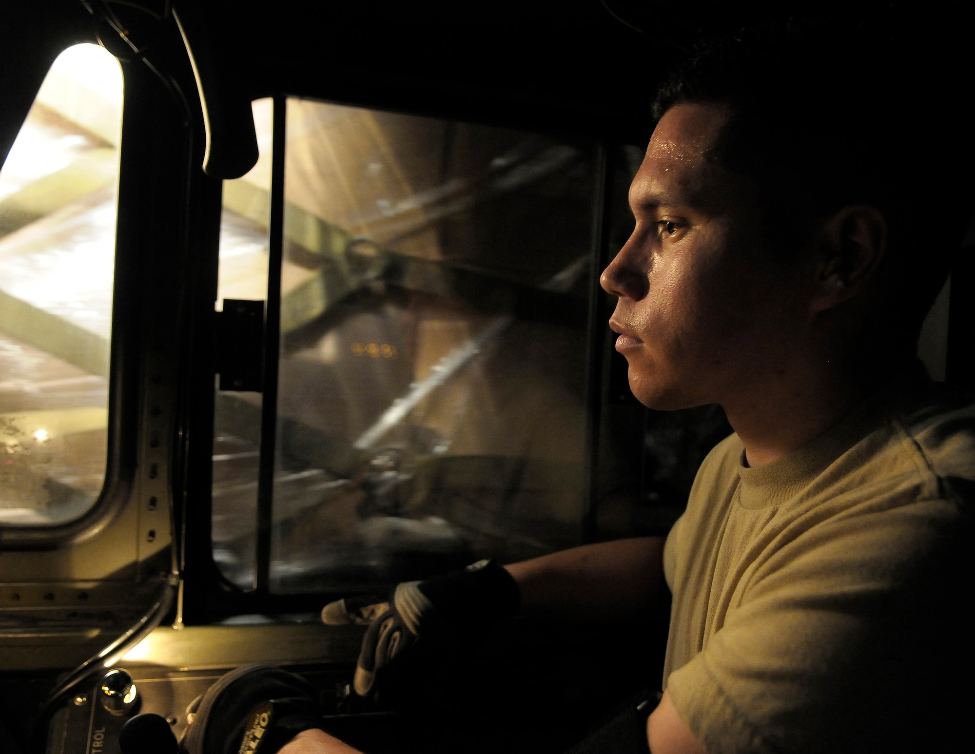 Airman Rodrigo Maranon drives a 60K loader with pallets of personal protection kits at Charleston Air Force Base, S.C., May 8. The personal protection kits were shipped to Haiti, El Salvador, Guatemala, Honduras and Nicaragua. The mission was flown by Airmen from the 437th Airlift Wing at Charleston AFB, with command and control oversight provided by the 618th Tanker Airlift Control Center at Scott AFB, Ill. (U.S. Air Force photo/James M. Bowman)