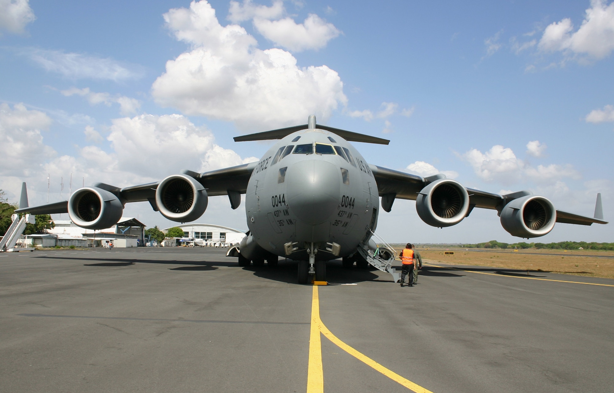 A C-17 Globemaster III from the 437th Airlift Wing at Charleston Air Force Base, S.C., sits on the ramp of Managua International Airport in Nicaragua May 9, after its crew offloaded cargo during a mission to deliver personal protective kits to help reduce the spread of the H1N1 influenza virus. The kits are part of a U.S. Agency for International Development shipment to Haiti, Guatemala, Honduras, El Salvador, Nicaragua and Belize to help these nations prepare for a potential outbreak of the H1N1 influenza virus. (U.S. Air Force photo/Raymond Sarracino) 