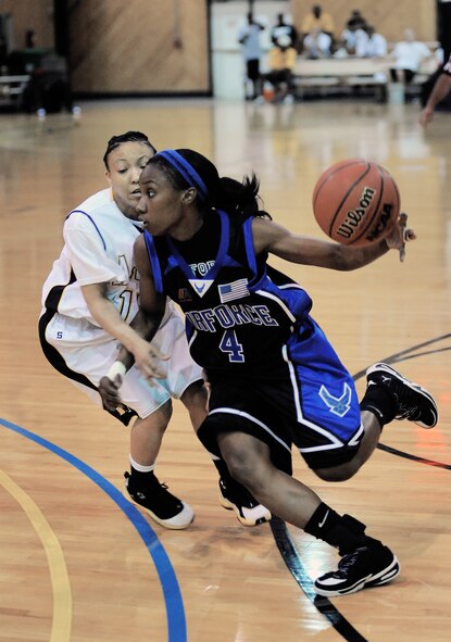 Second Lt. Monica Mason, from Tyndall Air Force Base, Fla., dribbles around an opponent during a basketball game against the Army.  The Air Force women beat the Army team 58-52 in the first round of games for the Armed Forces Basketball Championship in Millington, Tenn. The tournament will run from May 12th through the 17th.  (U.S. Navy photo/Petty Officer 1st Class John Collins)