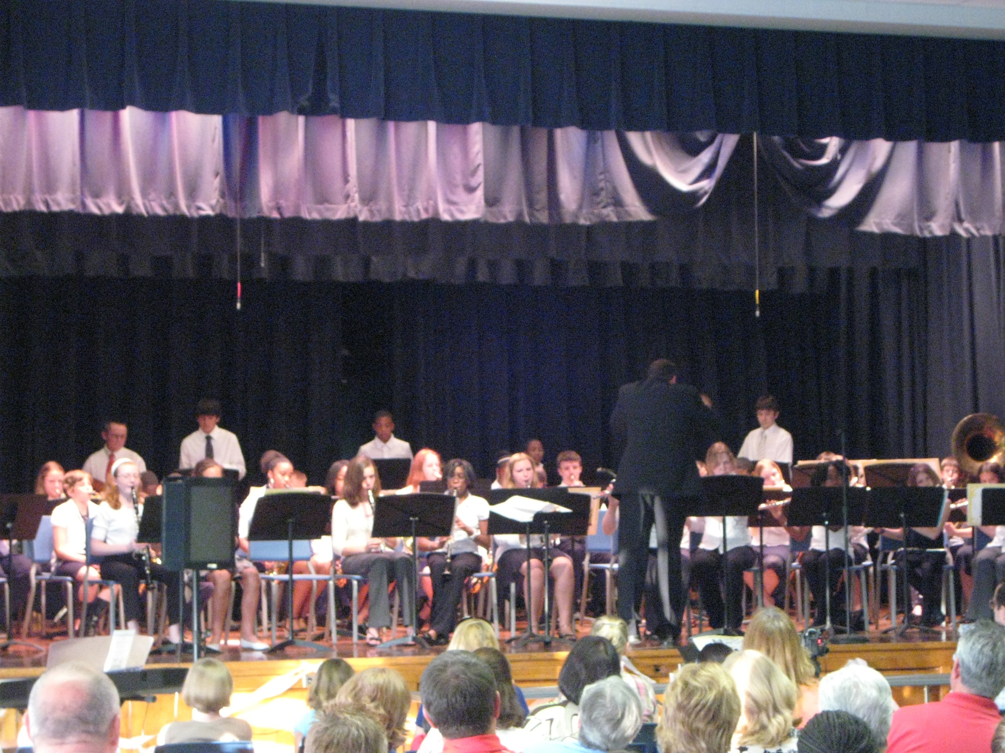 Air Base Middle School music director David DeLong conducts the school?s band during the Spring Concert at Dover Air Force Base May 12. Mr. DeLong teaches band, chorus and performing arts at the school and was recently named a Teacher of the Year for the Caesar Rodney School District. The other Teacher of the Year was his wife, Kathy DeLong, a fifth-grade teacher at W.B. Simpson. (U.S. Air Force photo by Tech. Sgt. Kevin Wallace)
