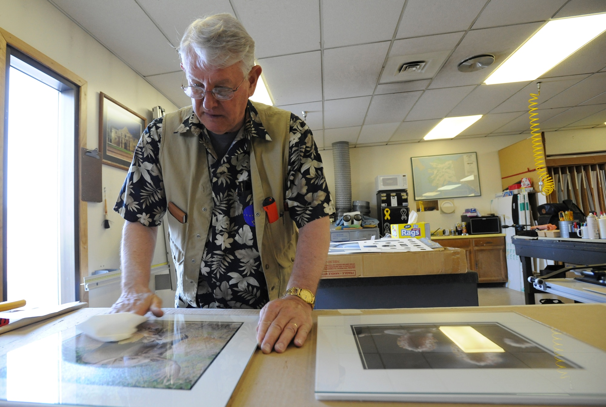ELMENDORF AIR FORCE BASE, Alaska -- Ken Baehr, retired Air Force Lt. Col, cleans some of the art he has just finished framing at the Arts and Crafts Center, May 5, 2009. The center provides services to military members and their families varying from shadow boxes, plaques, pottery, glass blowing and many more styles of art.(U.S. Air Force photo/Senior Airman Matthew Owens)