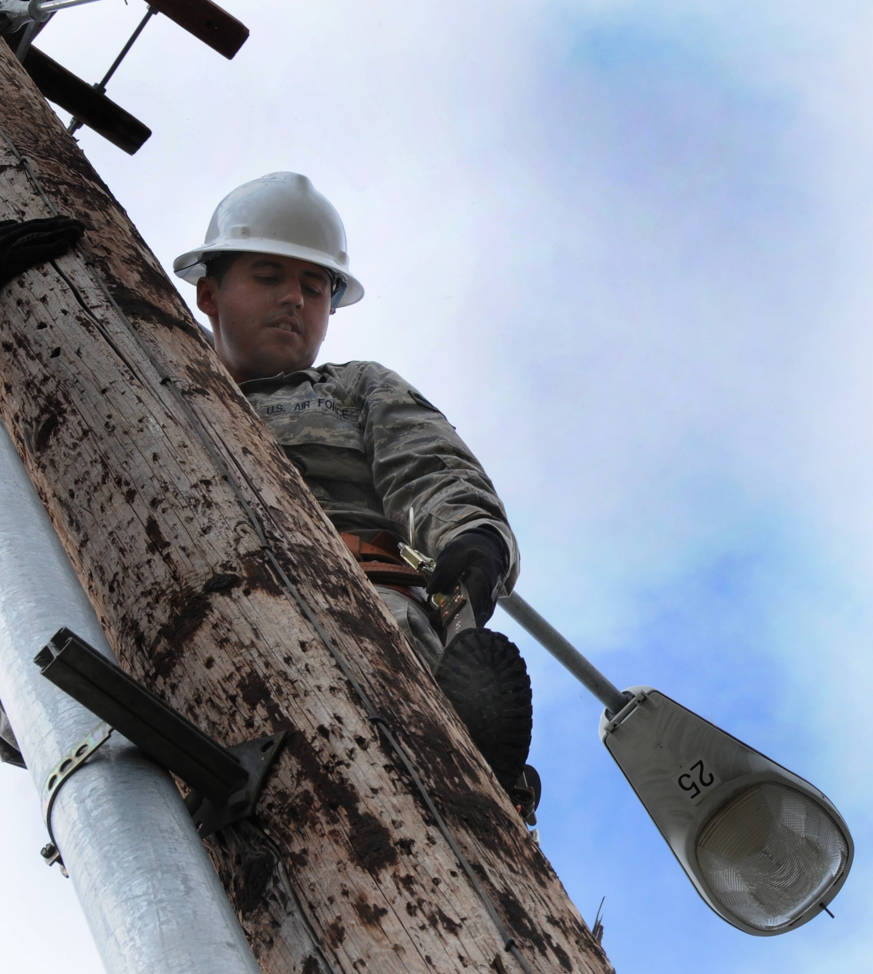 Airman 1st Class Alejandro Velazquez removes fuse cut-outs from a utility pole prior to demolition, May 12, 2009, Eielson Air Force Base, Alaska.  The poles are being removed to make a more aesthetically pleasing parking lot. Airman Velazquez is an Electrical Systems technician with the 354th Civil Engineering Squadron. (U.S. Air Force photo/Airman 1st Class Laura Max)