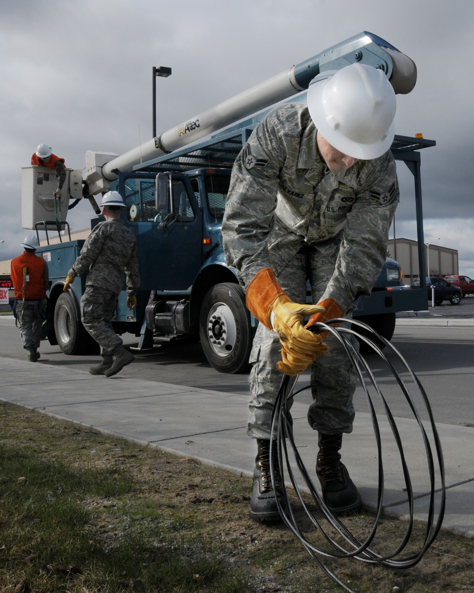 Airman 1st Class Rudy Alvarez removes cable for safety purposes prior to tearing down the old Burger King facility.  This project will help make a more aesthetically pleasing parking lot at the new Base Exchange. Airman Alvarez is an Electrical Systems technician with the 354th Civil Engineering Squadron. (U.S. Air Force photo/Airman 1st Class Laura Max)