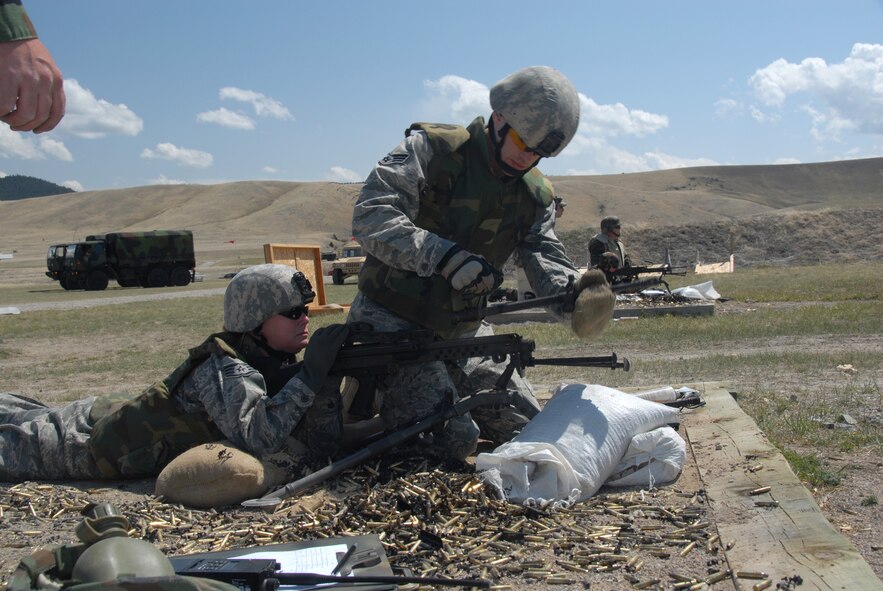 A member of the 185th Air Refueling Wing, Security Forces from Sioux City, Iowa, replaces the barrel of Squad Automatic Weapon (SAW) M-249 Light Machine Gun during qualification at Fort Harrison, Montana, on 11 May, 2009.  (U.S. Air Force photo by TSgt. Brian Cox)
