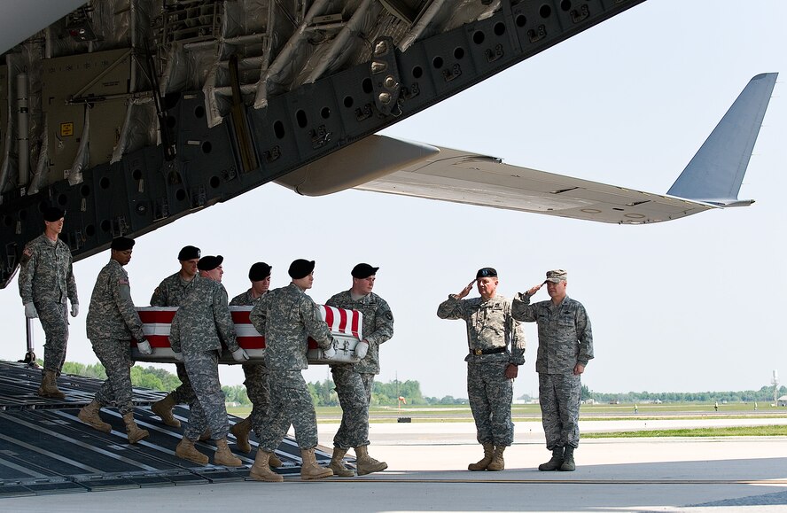 An Army carry team transfers the remains of Army Spc. Omar M. Albrak, of Chicago, Ill., at Dover Air Force Base, Del., May 12. Specialist Albrak was an Individual Ready Reserve soldier assigned to the Headquarters, Multi-National Forces, Iraq. (U.S. Air Force photo/Roland Balik)