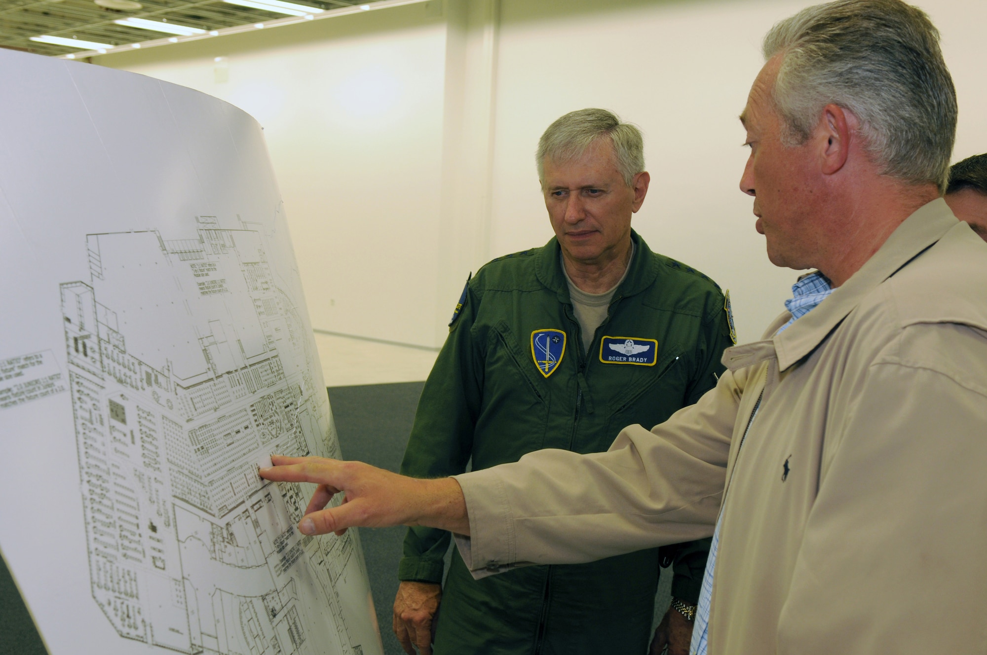 Tom Gross, Army and Air Force Exchange Service general manager, front, and Gen. Roger A. Brady, U.S. Air Forces in Europe commander, discuss where the different AAFES stores will be located in the Kaiserslautern Military Community Center, May 6, 2008, Ramstein Air Base, Germany. The KMCC will offer lodging, shopping, restaurants, movies and more under one roof when it opens this summer. (U.S. Air Force photo by Senior Airman Nathan Lipscomb)