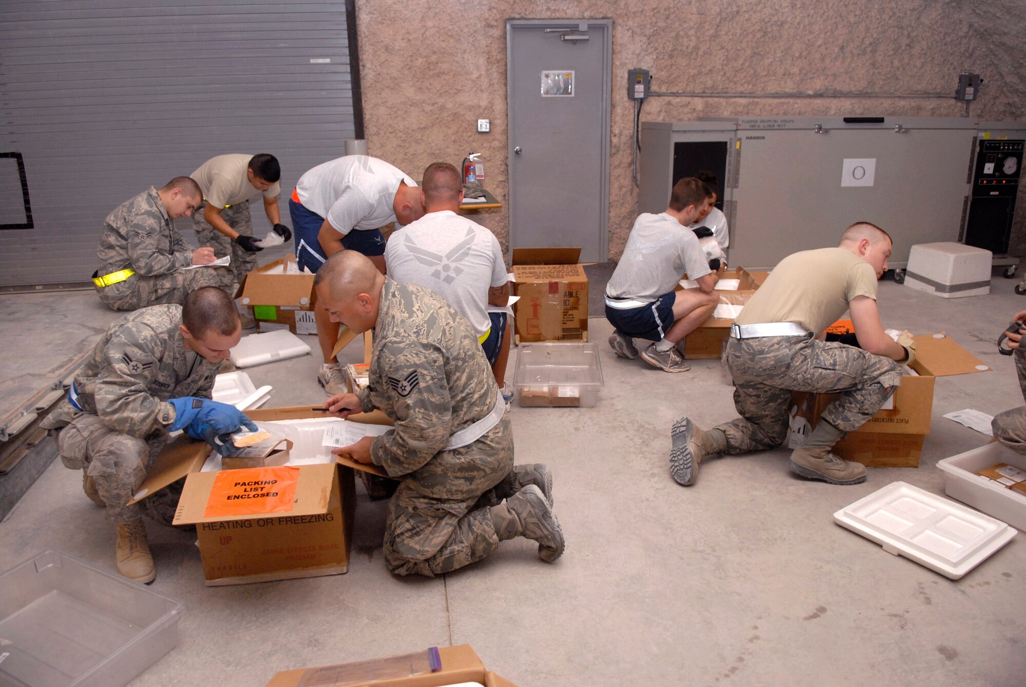 Volunteers from all over base come to assist Blood Transshipment Center (BTC) personnel inventory incoming blood products and to ensure they are ready to be forwarded on, May 9, 2009, at an undisclosed location in Southwest Asia.  The BTC receives blood products from stateside locations, then temporarily stores and redistributes them to various locations in the U.S. Central Command's Area of Responsibility.  The military members who volunteer are deployed in support of Operations Iraqi and Enduring Freedom and Combined Joint Task Force - Horn of Africa.  (U.S. Air Force photo/Senior Airman Andrew Satran/released)
