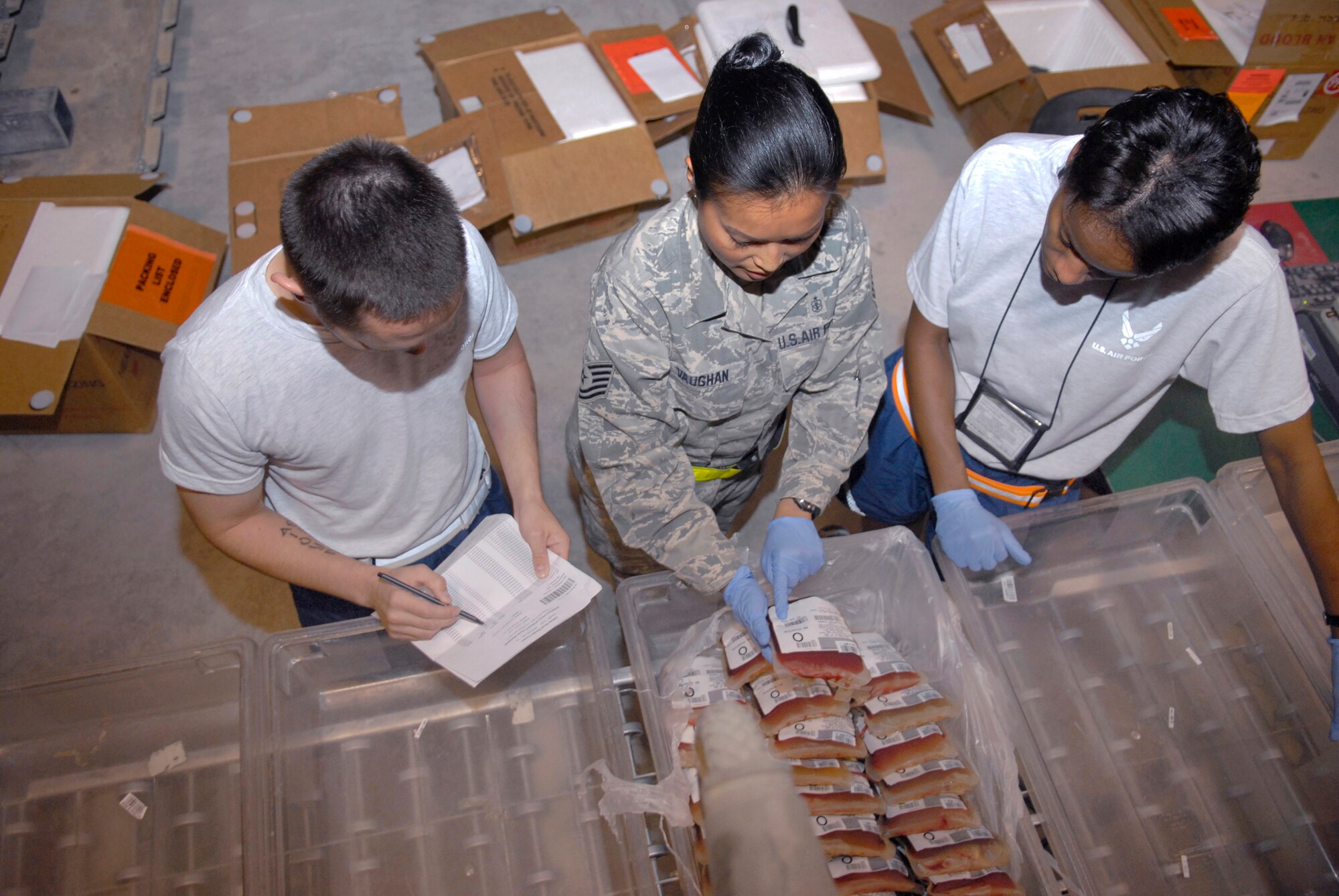Staff Sgt. Anthony Bradford, a 379th Expeditionary Medical Group (EMDG) volunteer, Tech. Sgt. Marilou Vaughan, a 379th EMDG lab technician, and 1st Lt. Jacquelyn Smith, also a 379th EMDG volunteer, helps inventory units of red blood cells in the Blood Transshipment Center (BTC), May 9, 2009, at an undisclosed location in Southwest Asia.  The BTC uses a steady stream of volunteers to assist in inventorying incoming blood products and preparing them for distribution throughout the U.S. Central Command's Area of Responsibility.  Sergeant Bradford hails from Gulf Port, Miss. and is deployed from Keesler Air Force Base.  Sergeant Vaughan hails from Fort Worth, Texas and is deployed from Travis Air Force Base, Calif.  1st Lt. Smith hails from Douglas, Ga. and is deployed from Keesler Air Force Base, Miss.  All are deployed in support of Operations Iraqi and Enduring Freedom and Combined Joint Task Force - Horn of Africa.  (U.S. Air Force photo/Senior Airman Andrew Satran/released)