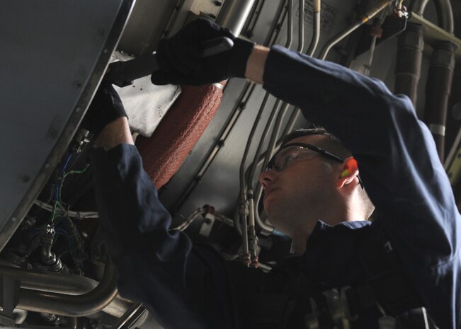 Airman 1st Class Joseph Dooley opens the thrust reverser doors on a C-17 here May 12 to get a better look at the engine during the logistics standardization evaluation program inspection. Airman Dooley is a jet engine mechanic with the 437th Maintenance Squadron. (U.S. Air Force photo/Senior Airman Katie Gieratz)