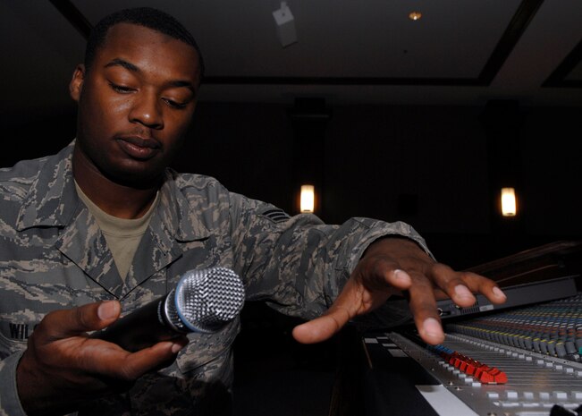 Senior Airman Terry Wilson tests a microphone before the start of Air Mobility Command's unit compliance inspection team's in-brief at the Charleston AFB theater May 11. The ground radio shop provides communication support and maintenance to Charleston AFB with land mobile radios, mass notification systems as well as other transmission systems. Airman Wilson is a radio maintenance technician with the 437th Communications Squadron. (U.S. Air Force photo/Senior Airman Katie Gieratz)