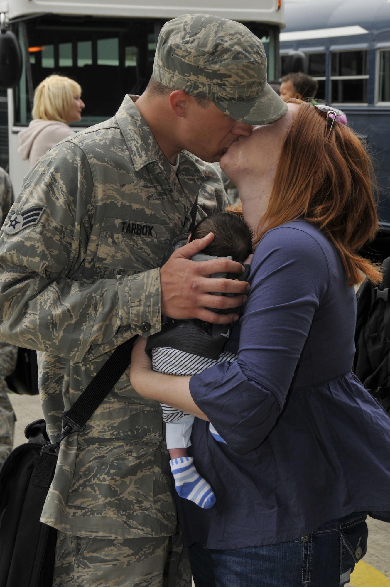 ROYAL AIR FORCE LAKENHEATH, England -- Hazel Tarbox and their newborn son, Cody, welcome home her husband, Senior Airman Eric Tarbox, 48th Munitions Squadron, after returning from Afghanistan May 13, 2009. Over 250 Airmen returned from a four month deployment to Afghanistan in support of Operation Enduring Freedom. (U.S. Air Force photo by Airman 1st Class Perry Aston) 